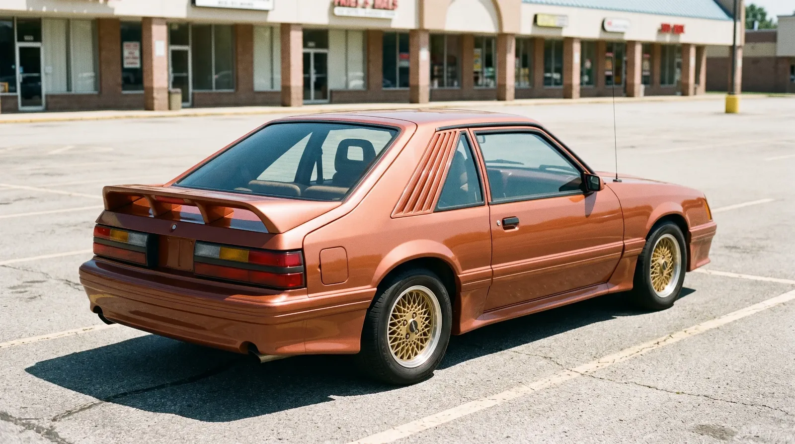 1984 Saleen Mustang, rear wing and louvered quarter windows in an empty lot