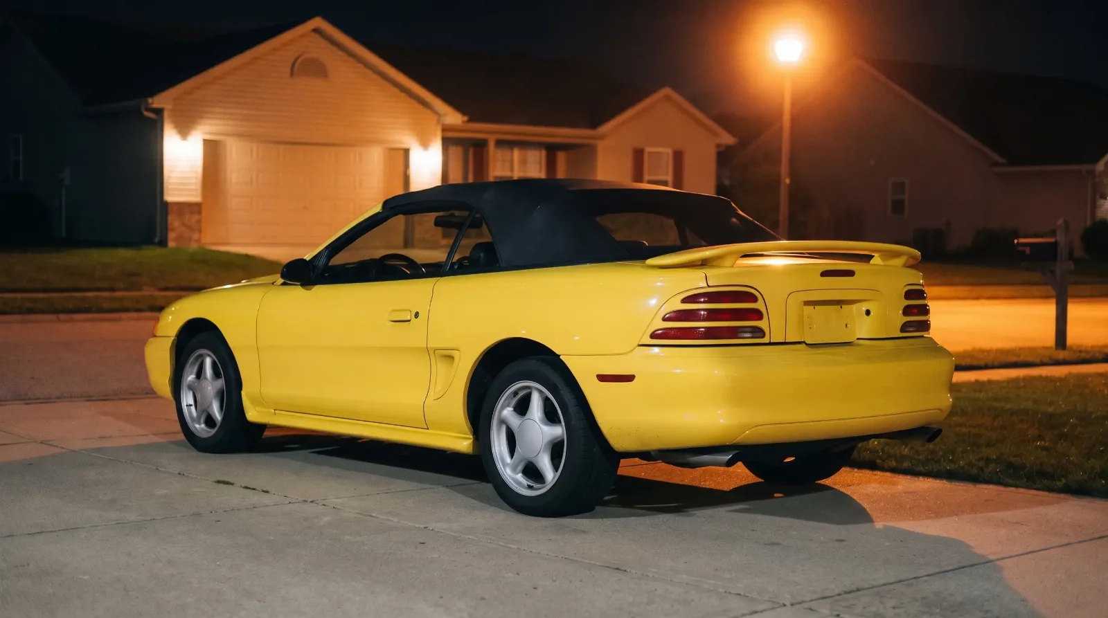 1994 Ford Mustang GT convertible, in a driveway at night