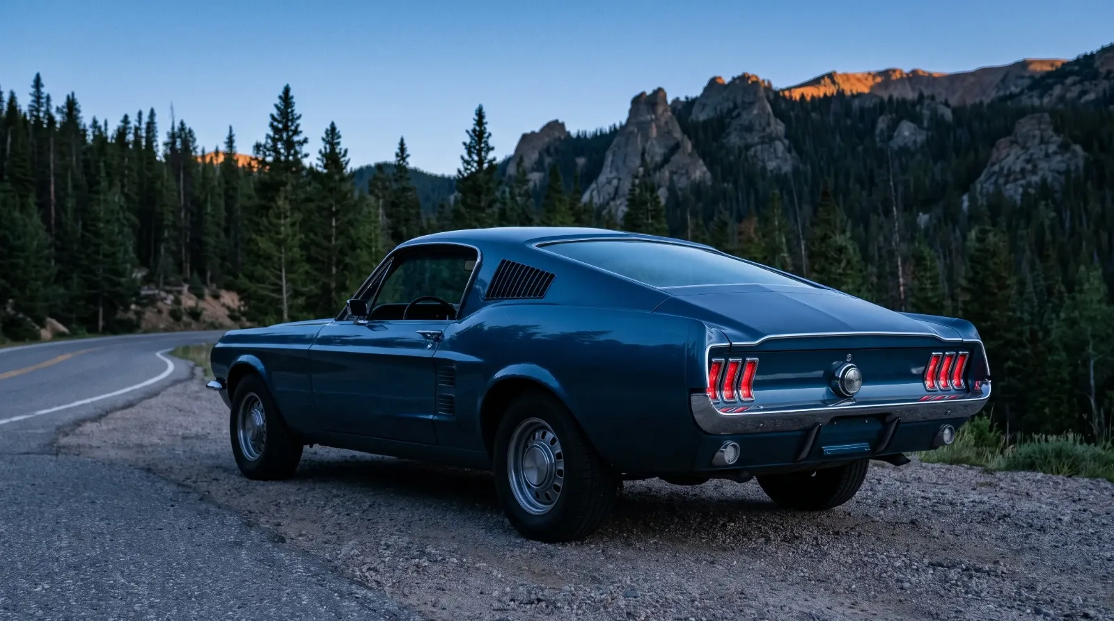 1967 Ford Mustang fastback, plain sides at dusk on a mountain pass