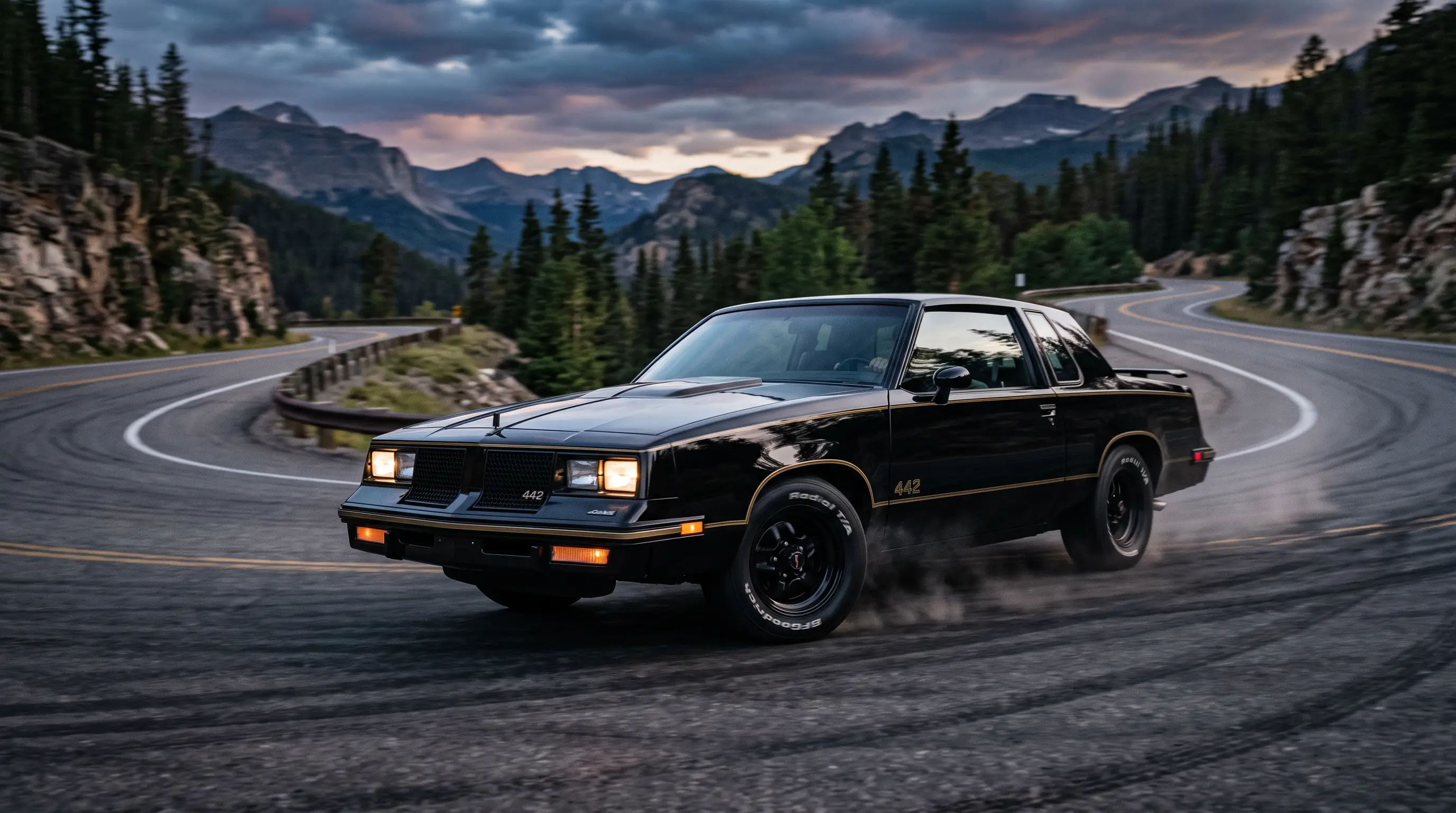 1986 Oldsmobile Cutlass 442 G body coupe on a twisting mountain road at dusk