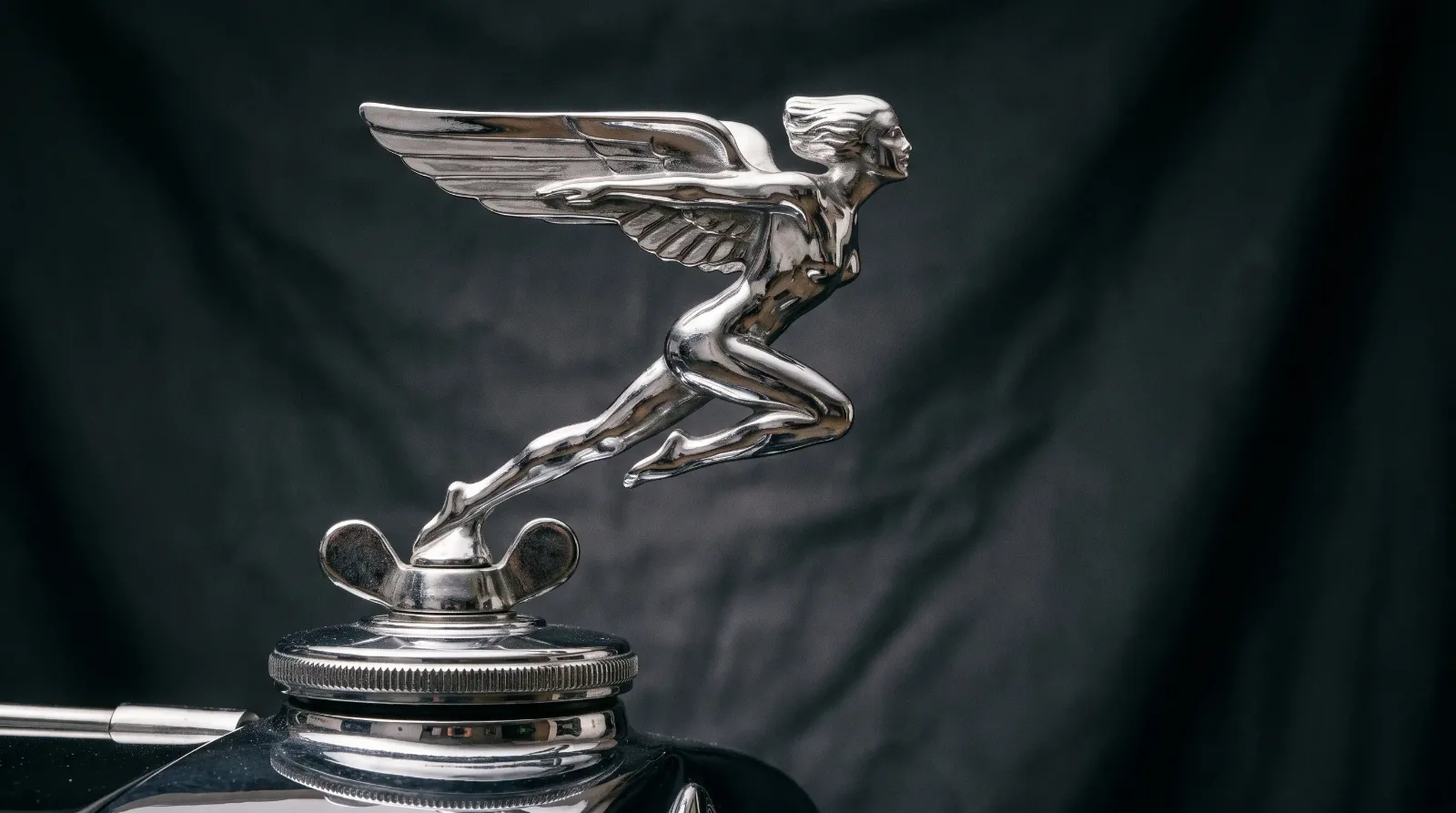 1930s art deco chrome hood ornament in studio light
