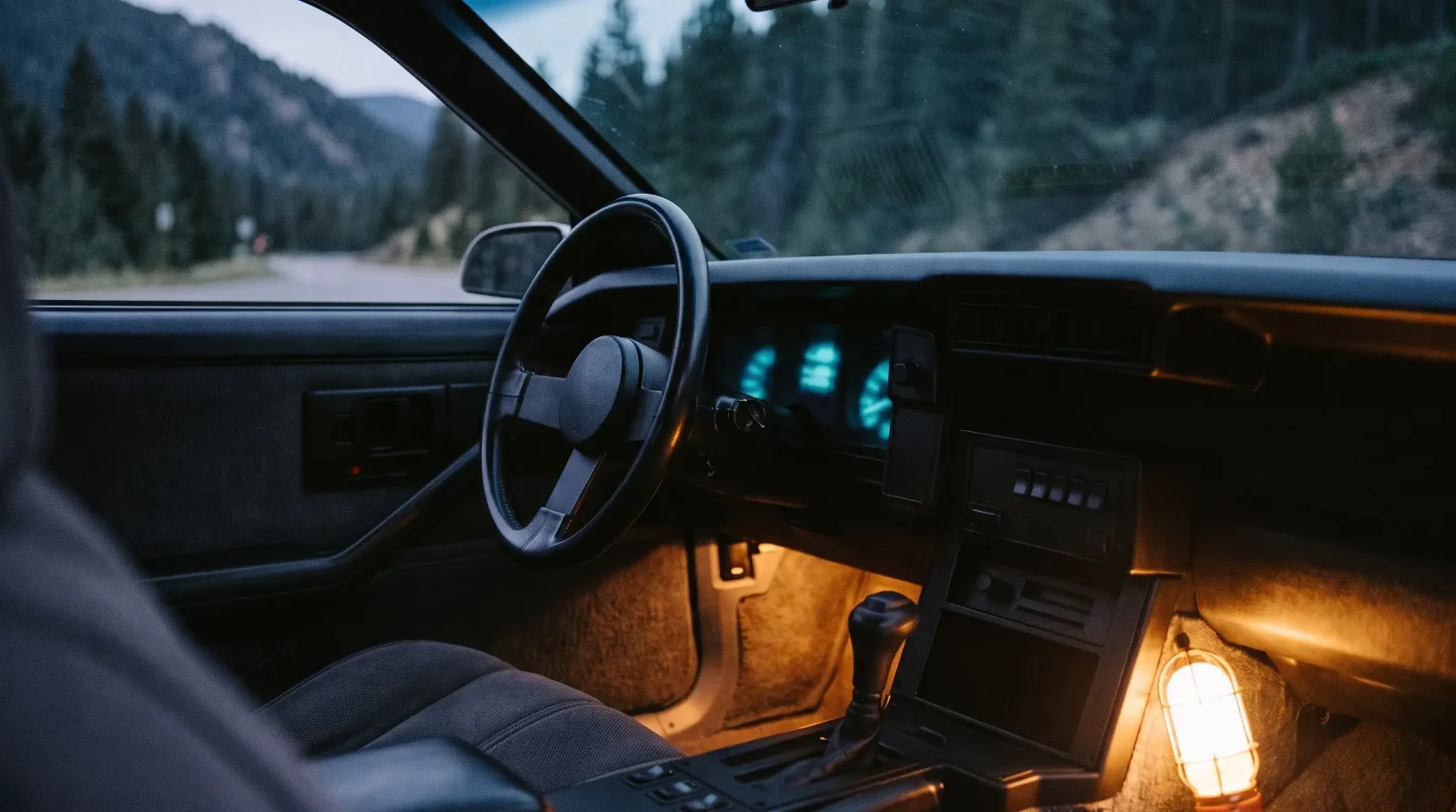 1984 Chevrolet Camaro Berlinetta, glowing dash on a mountain pass