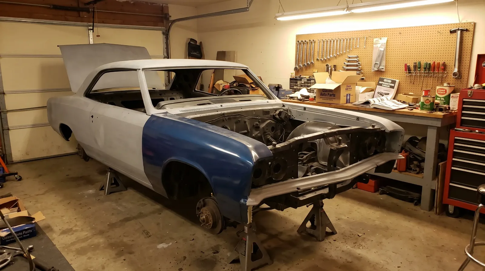 Chevrolet Chevelle mid-restoration on jack stands in a home garage