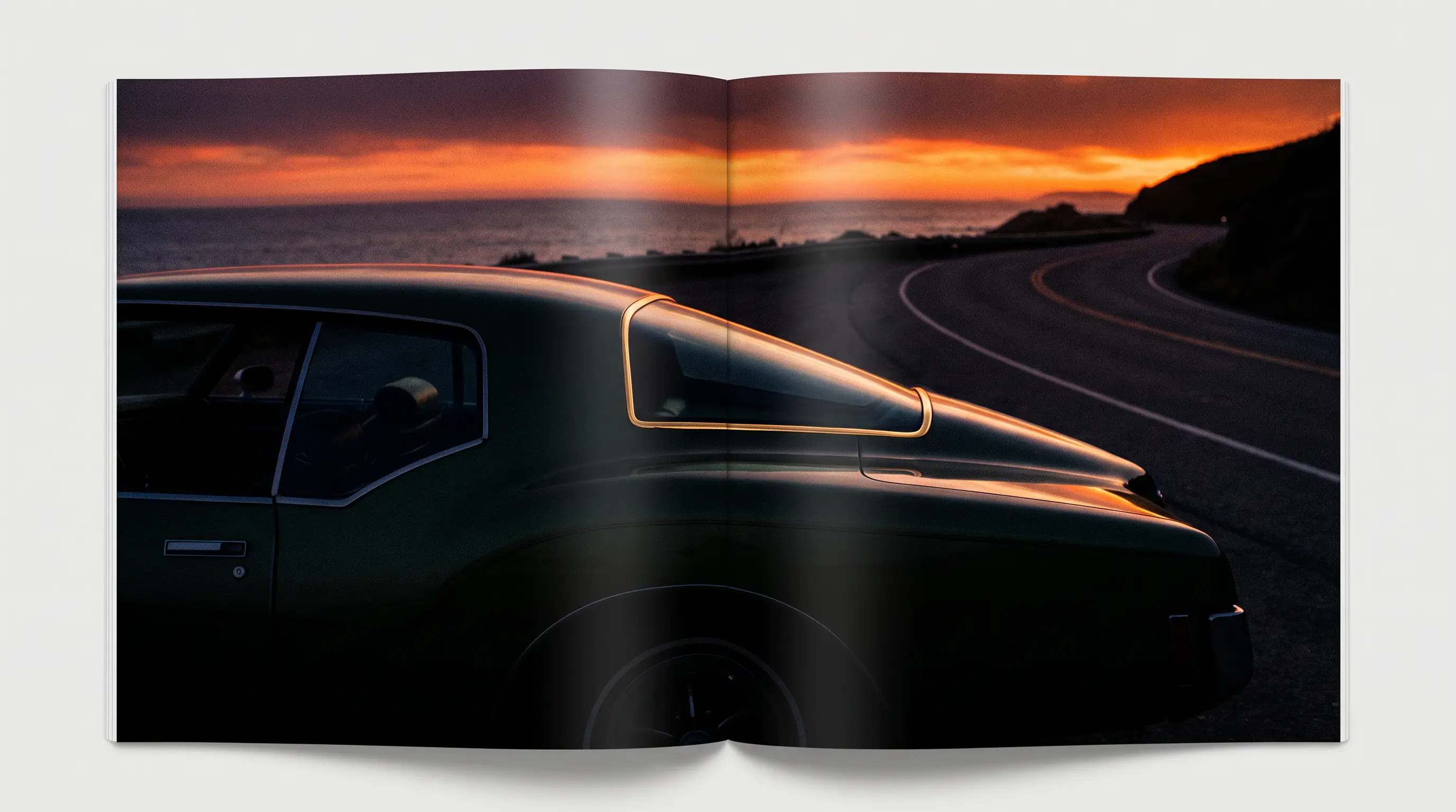 Dark green boat tail Riviera in side profile silhouette against a coastal sunset