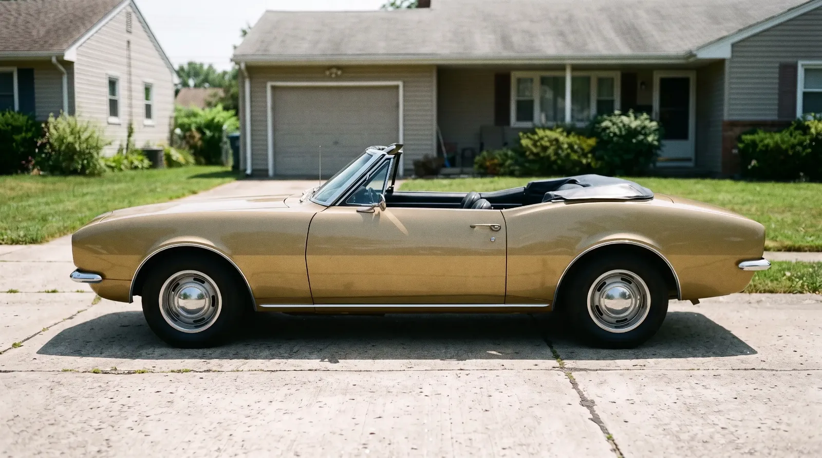 1967 Chevrolet Camaro convertible, top down on a suburban driveway