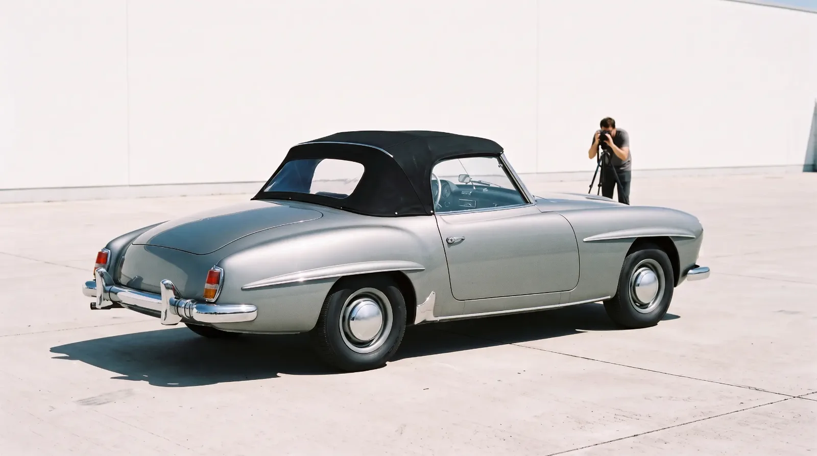 A 1955 Mercedes-Benz 190 SL photographed against a plain wall for a dealer listing