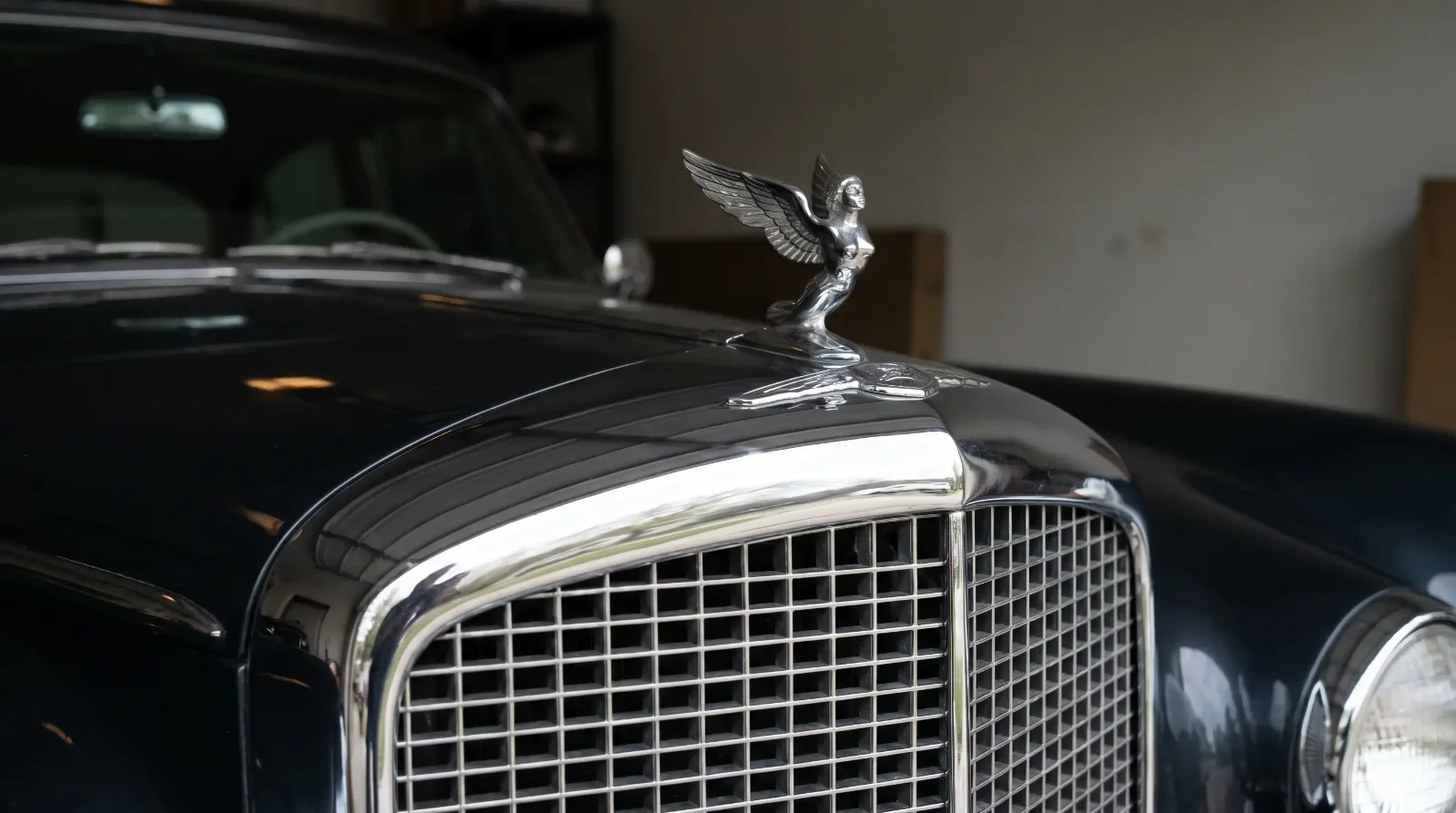 Classic luxury car grille and chrome hood mascot