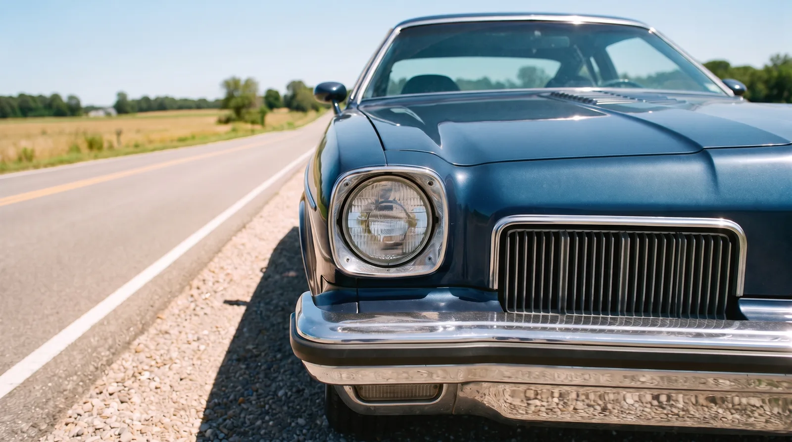 1973 Oldsmobile Cutlass S 442 — front corner on an empty country road