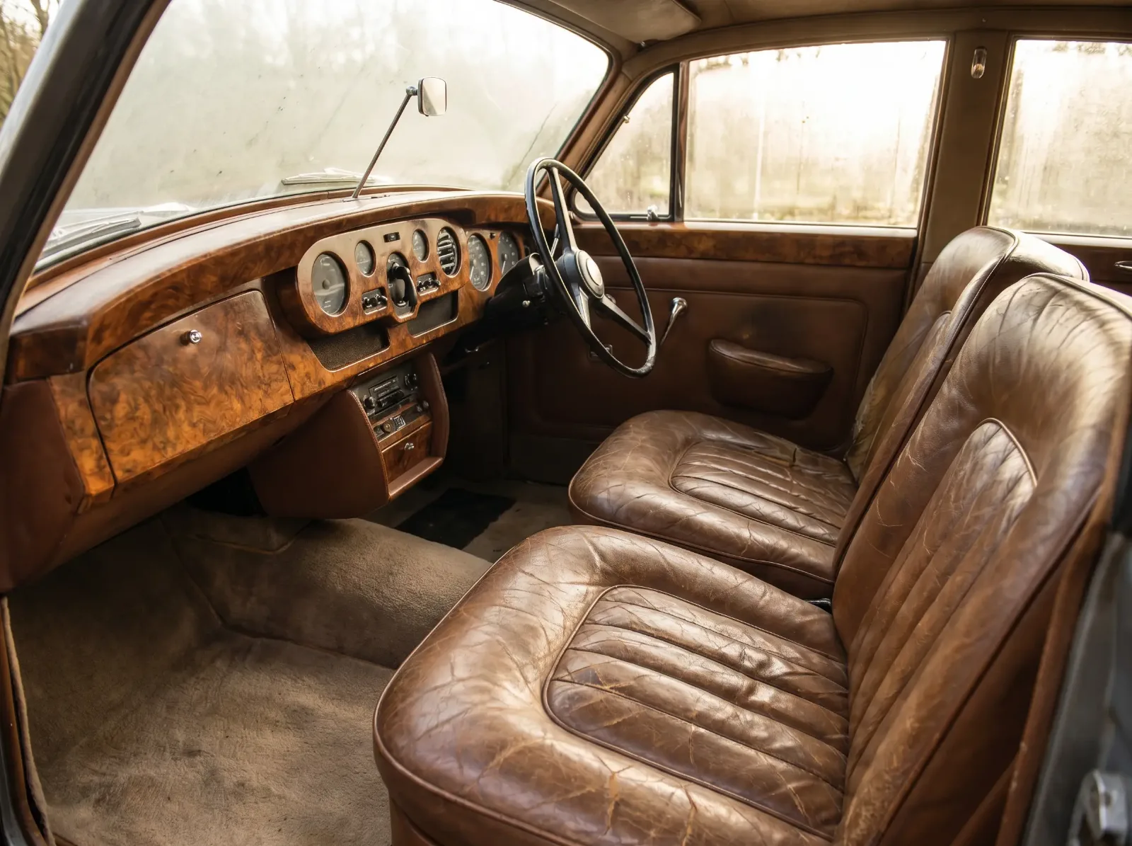 Burl walnut dashboard and aged leather seats