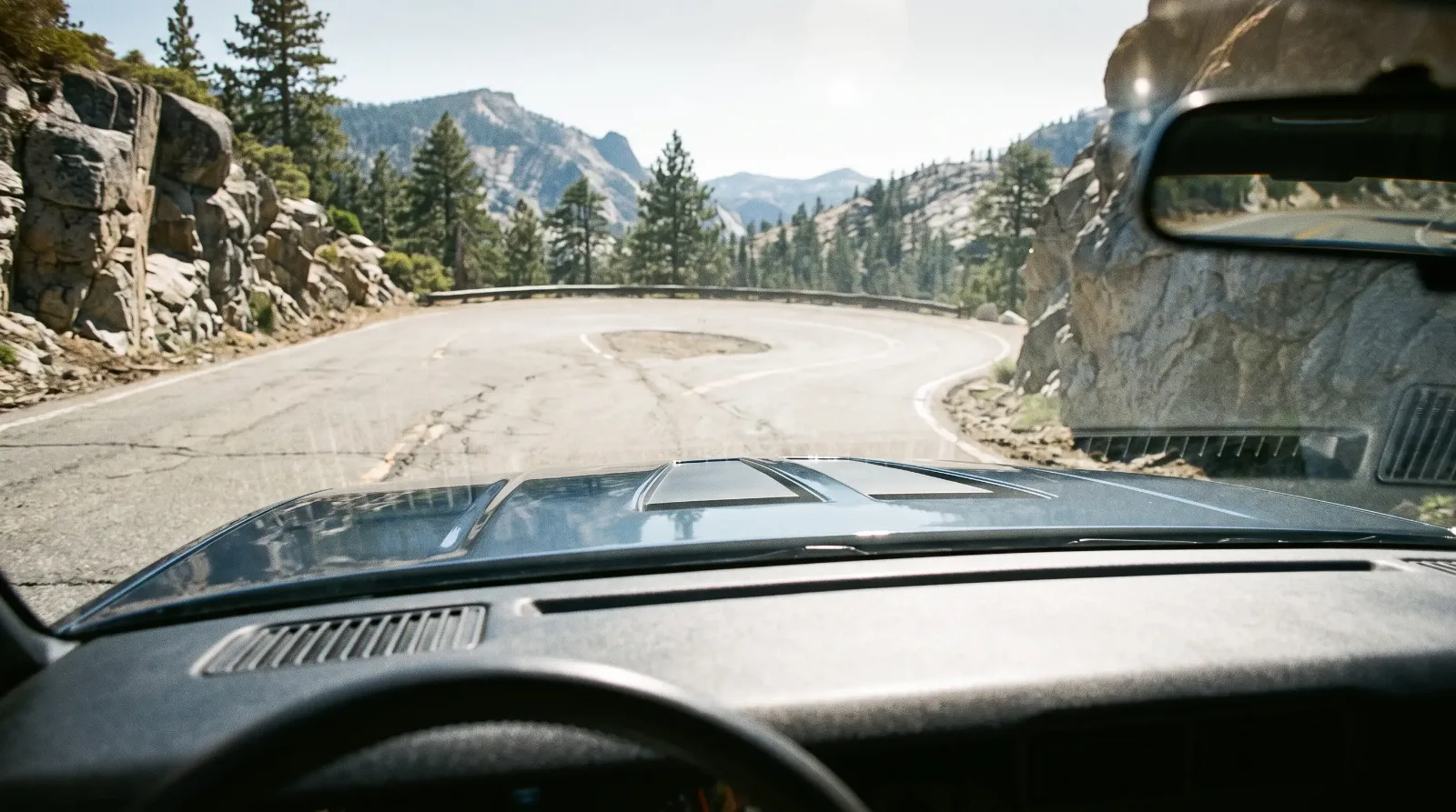 1982 Chevrolet Camaro Z28 hood air-induction flaps seen from the driver's seat on a mountain pass