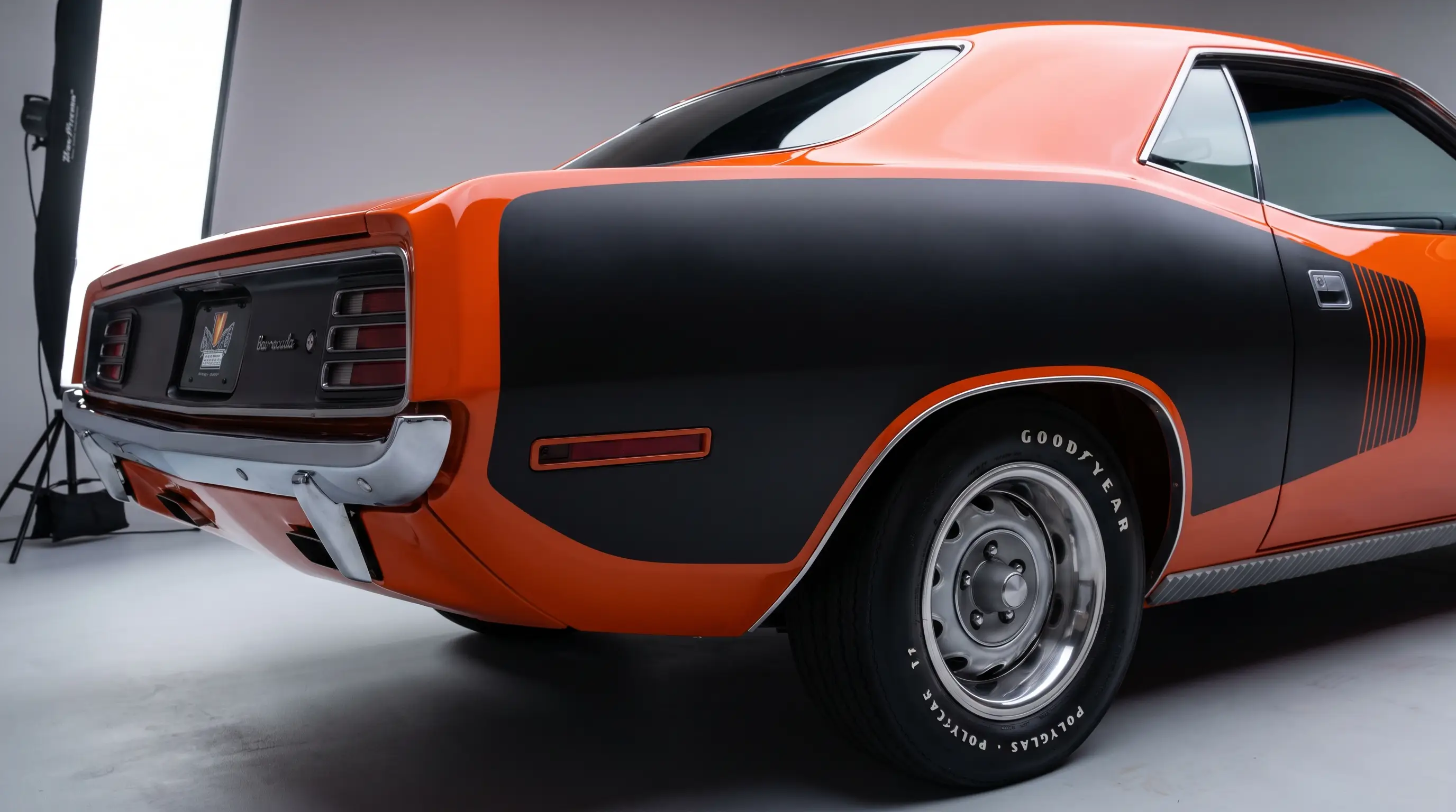 Close up of orange Plymouth Barracuda rear quarter with black billboard stripe