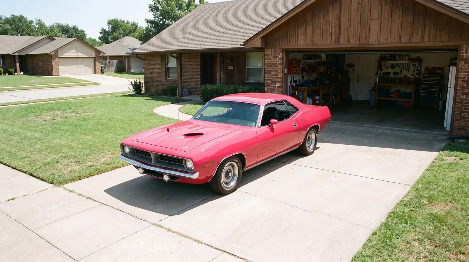 1970 Plymouth Cuda — Moulin Rouge pink on a home driveway