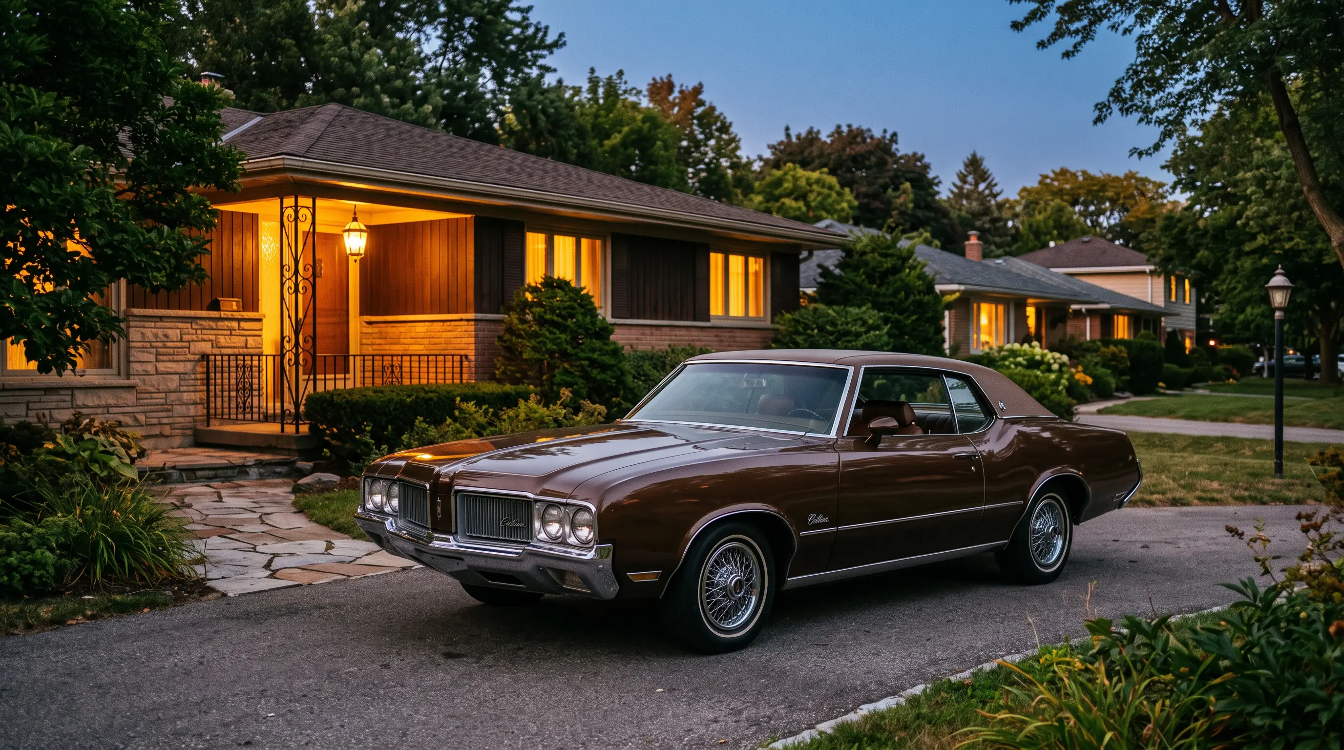 Brown 1970s Oldsmobile Cutlass Supreme parked in a suburban driveway at dusk
