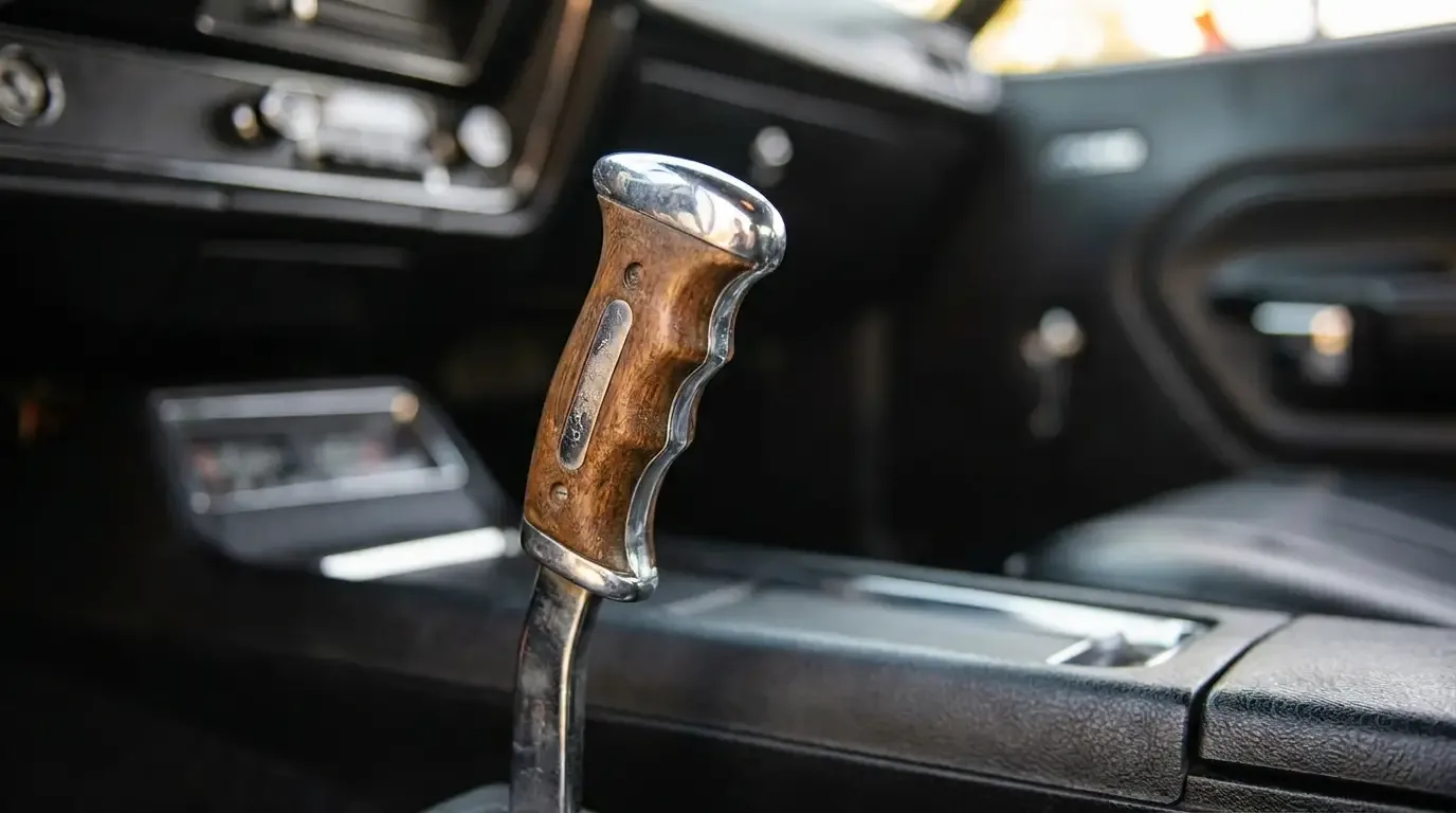 Close-up of a Hurst pistol-grip shifter handle in a classic Mopar