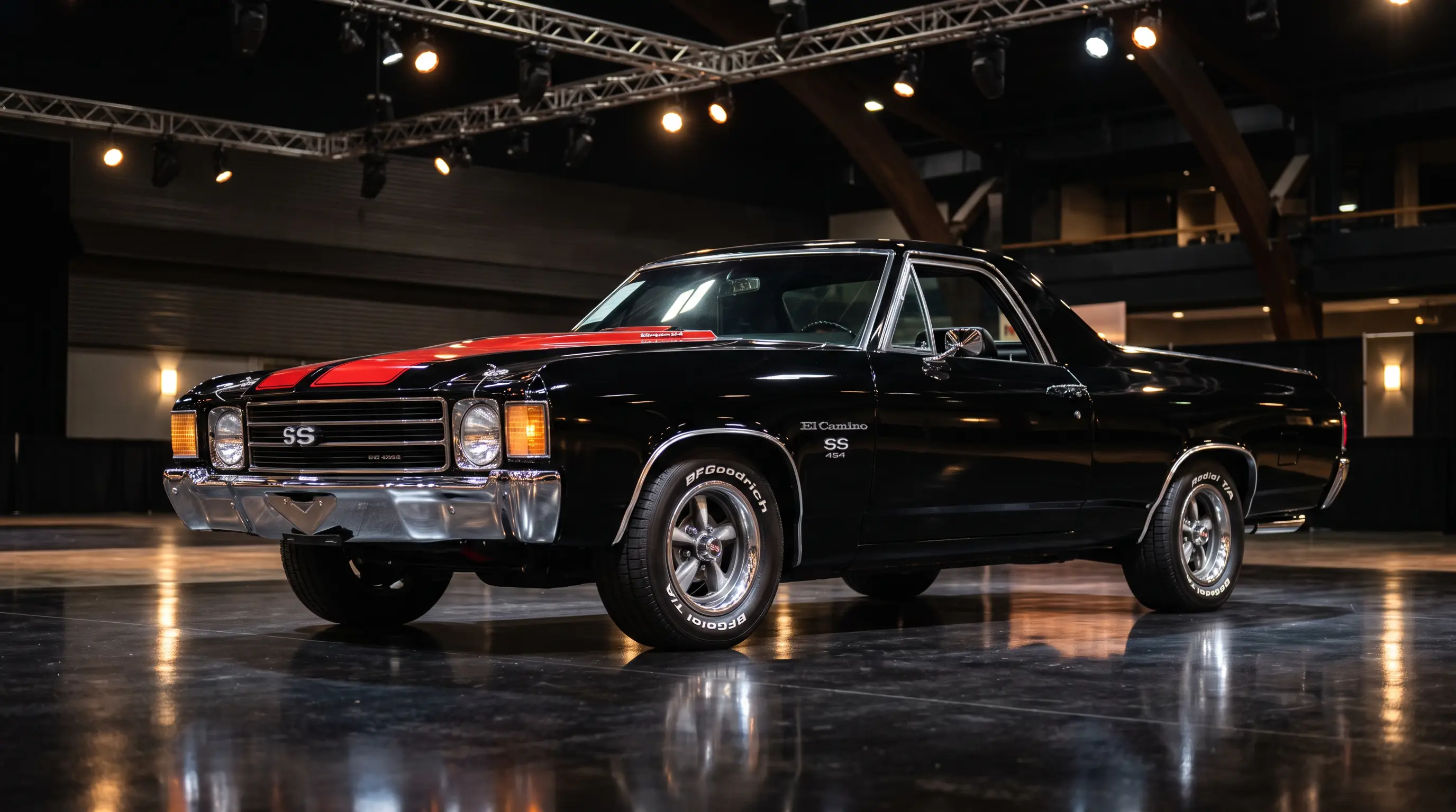 Black 1972 El Camino SS 454 spotlighted on an auction house floor
