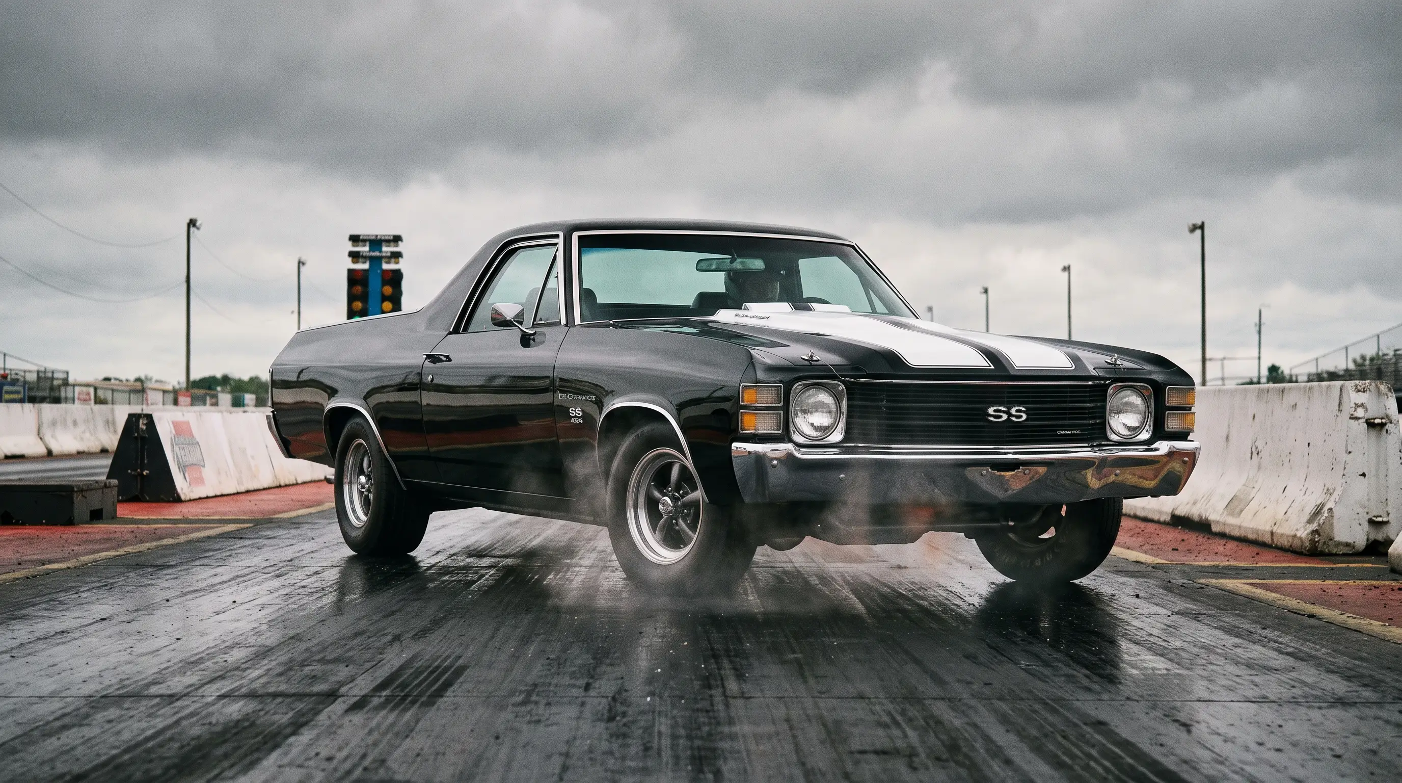 1972 Chevrolet El Camino SS 454 in black with white stripe staged at a drag strip under overcast sky