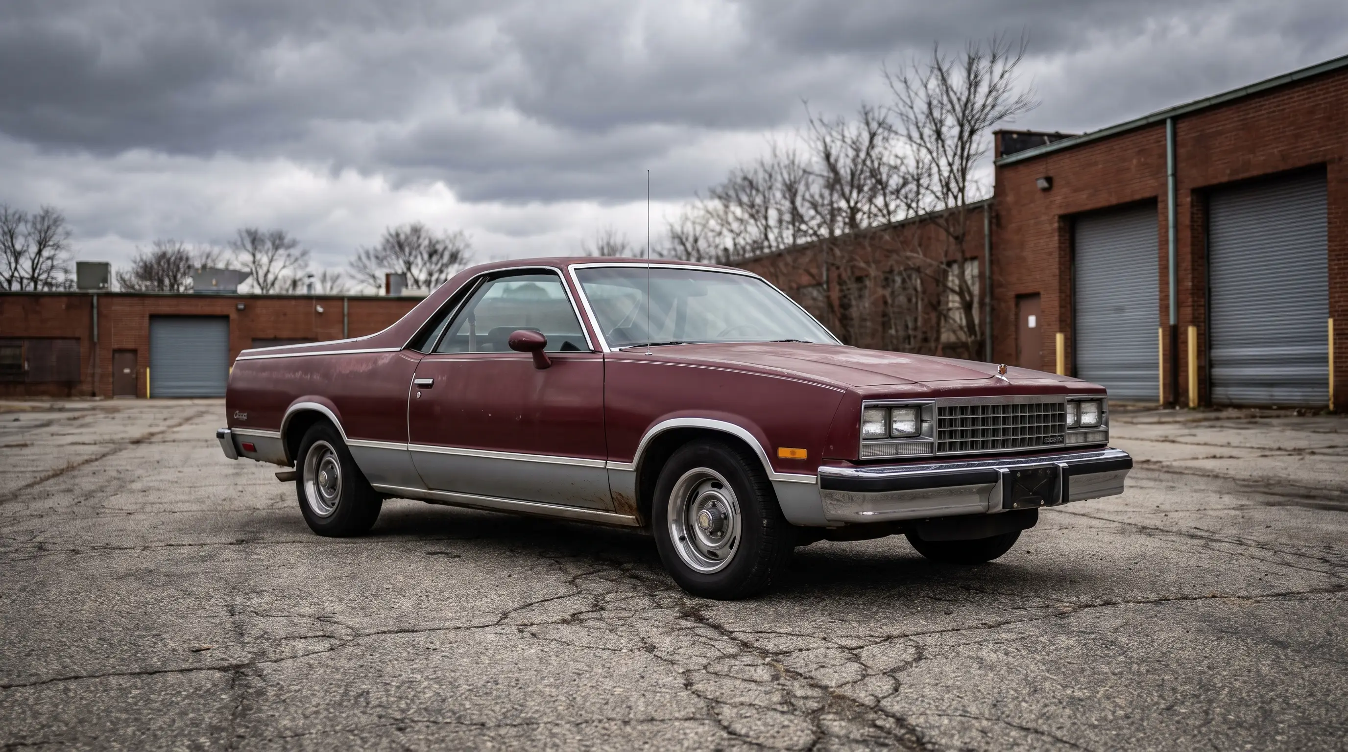1985 Chevrolet El Camino in a quiet industrial lot under overcast dramatic light