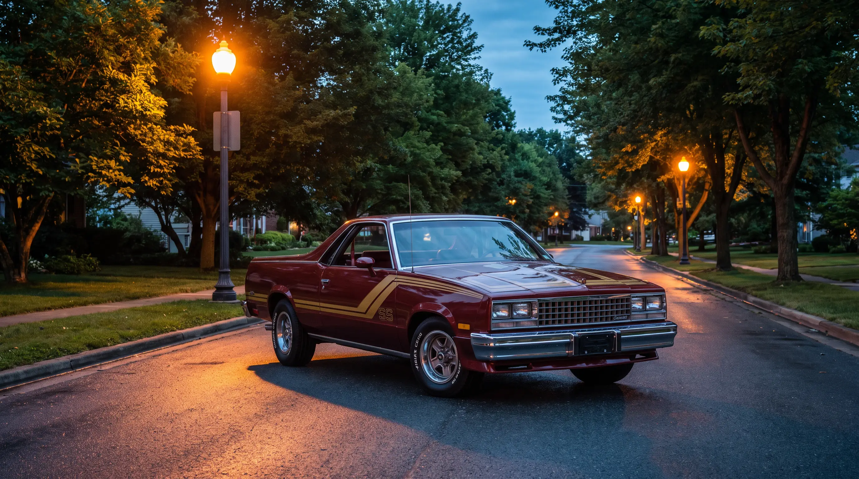 Maroon 1980s Chevrolet El Camino SS with decal stripes on a suburban street at dusk