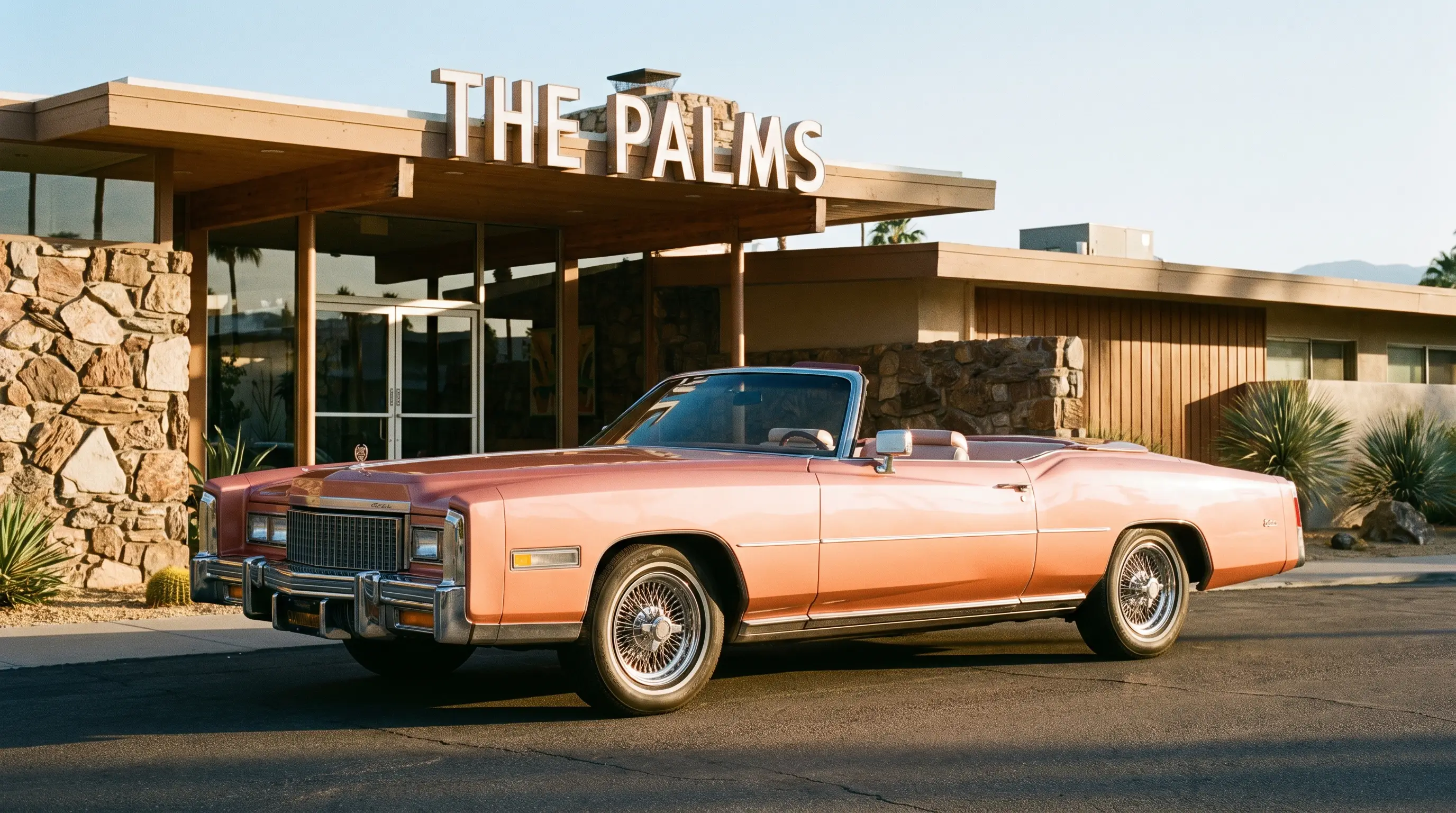 1976 Cadillac Eldorado convertible top down outside a grand mid-century hotel