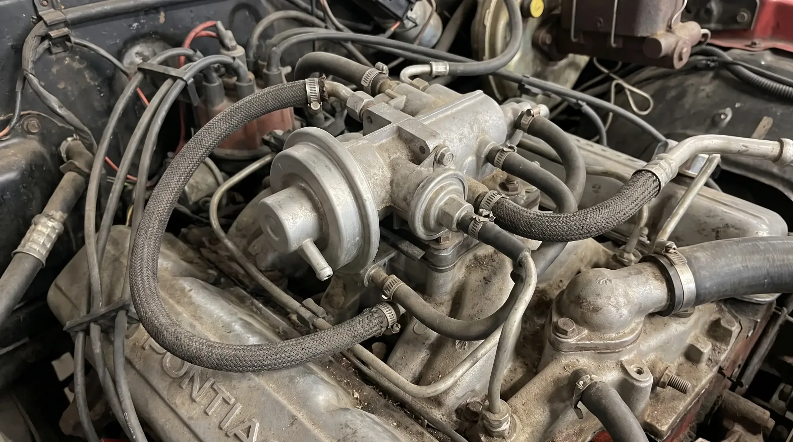 EGR valve and emissions plumbing on 1970s V8