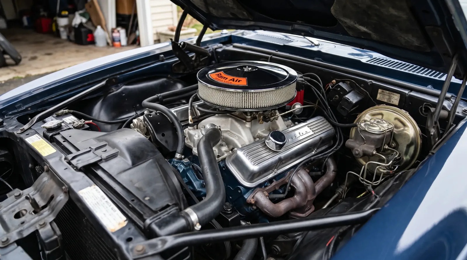 Engine bay detail of a 1967 Pontiac Firebird 400 cubic inch Ram Air V8 with chrome air cleaner