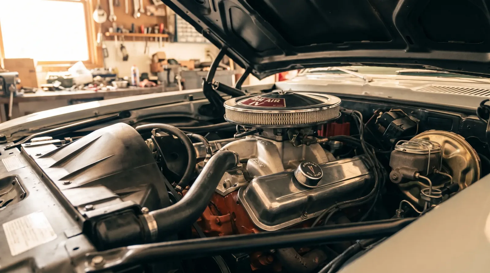 Close-up of a 1969 Pontiac Firebird Ram Air IV 400 V8 engine with round-port heads and aluminum intake