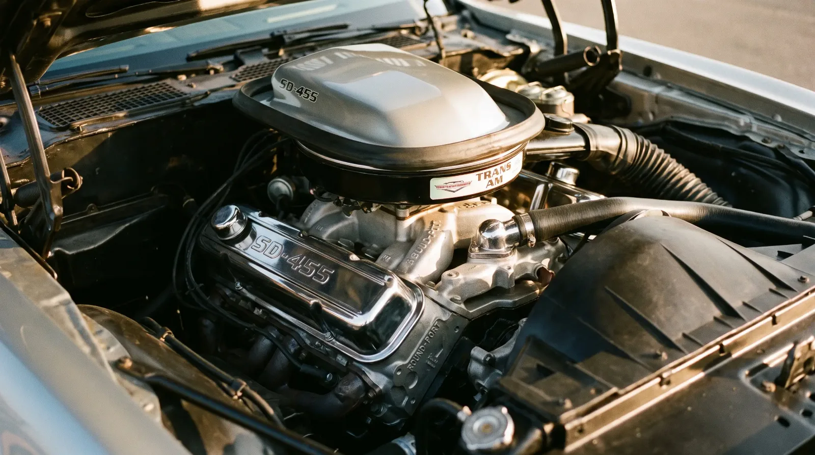 Engine bay detail of a 1973 Pontiac Firebird Trans Am SD-455 big block with round-port heads and shaker scoop