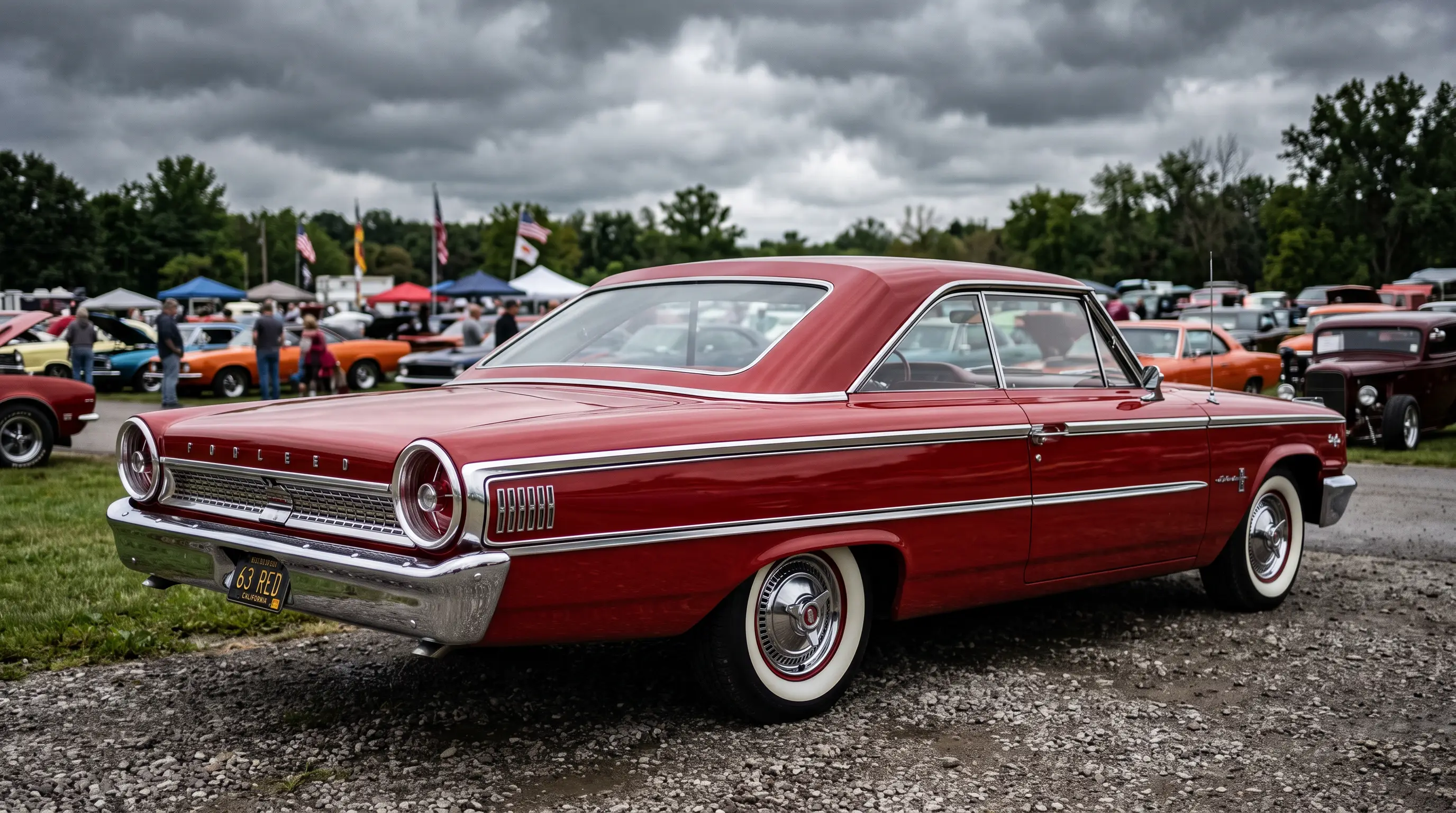Rangoon red 1963 Ford Galaxie 500 fastback at a vintage car show under overcast sky