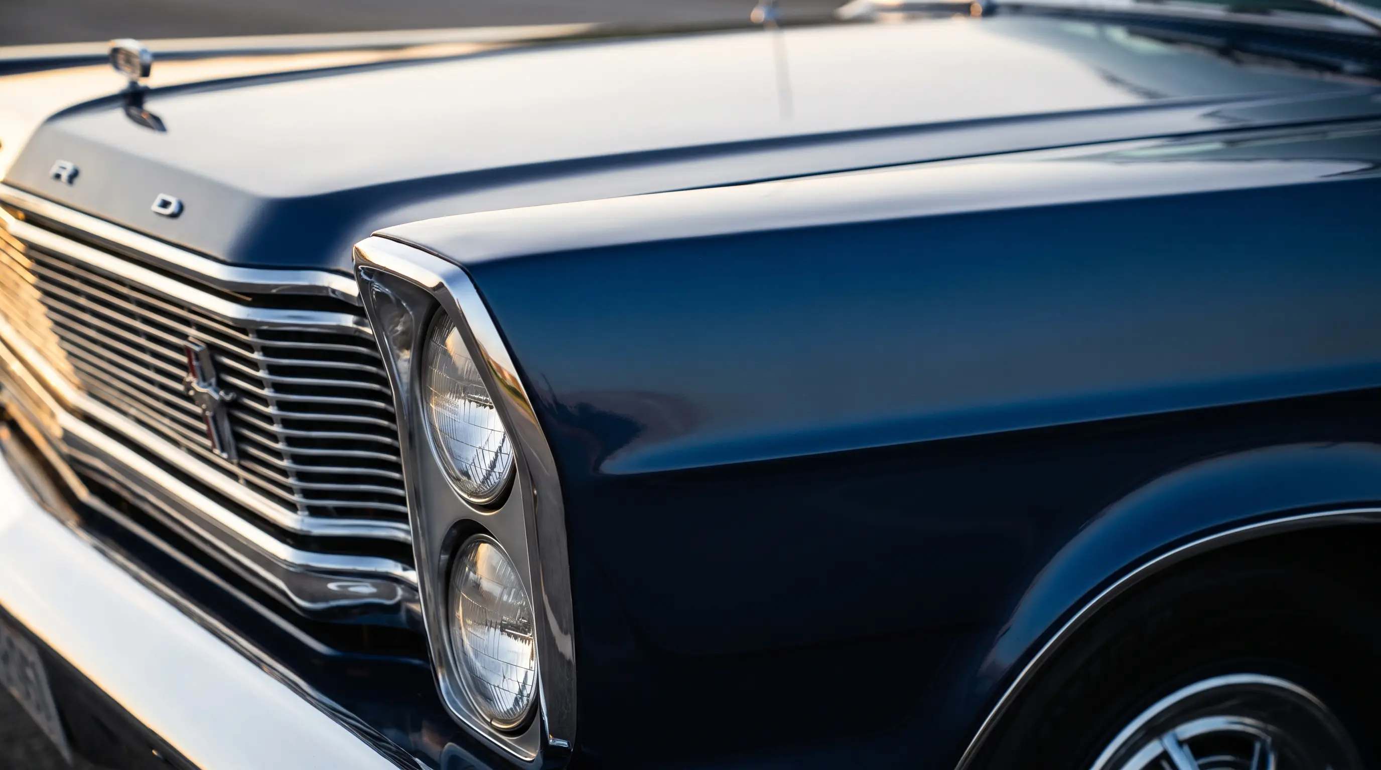 Close up of a deep blue 1965 Ford Galaxie 500 showing stacked headlights and chrome trim