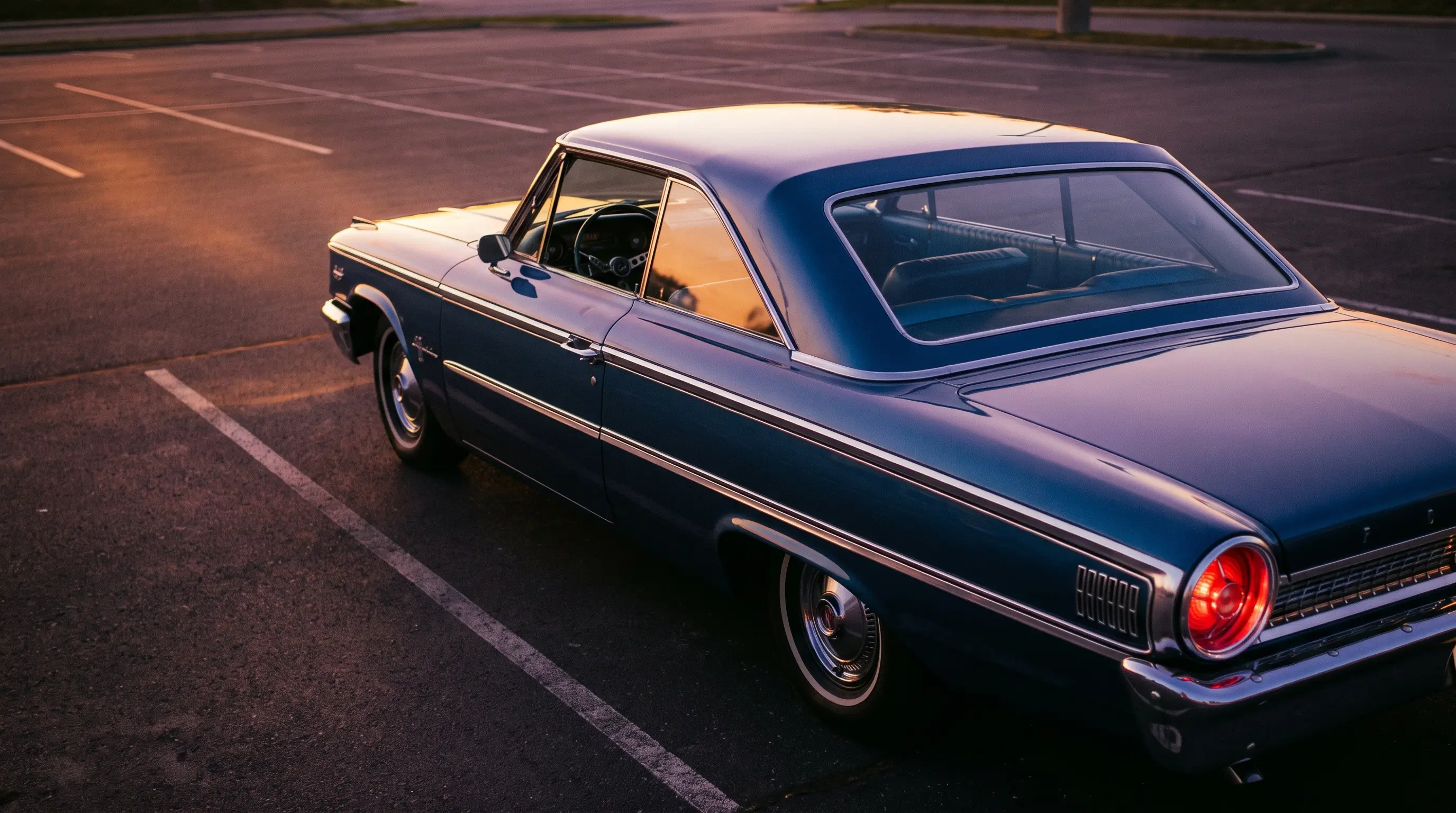 1963 Ford Galaxie 500 XL Sports Hardtop fastback rear angle in a parking lot at dusk