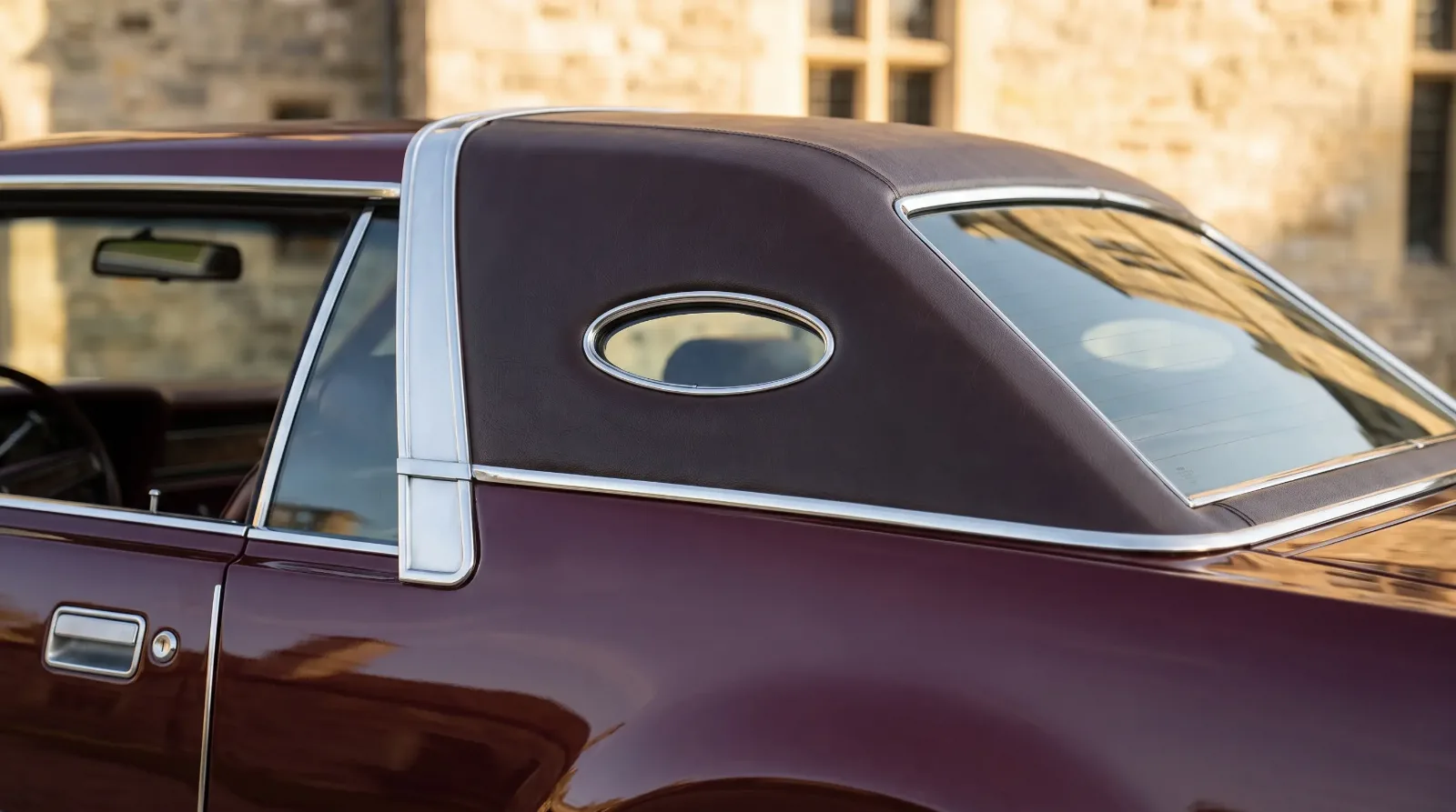 Rear roofline detail of a 1970s Lincoln Continental formal luxury coupe with padded C-pillar and opera window