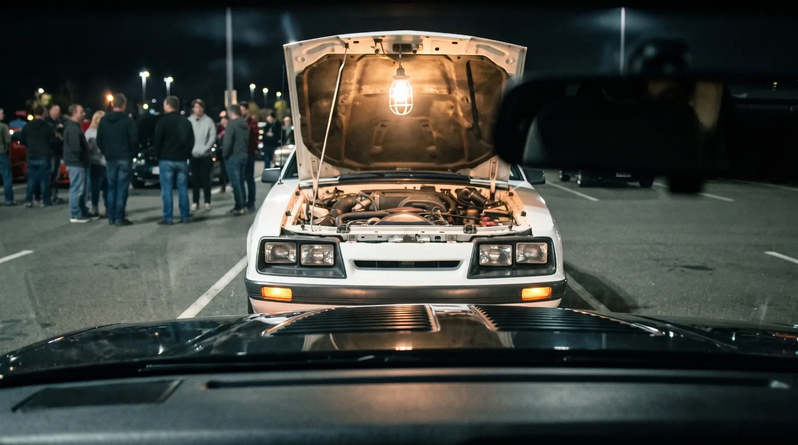 1985 Ford Mustang GT and Camaro Z28, nose to nose at night
