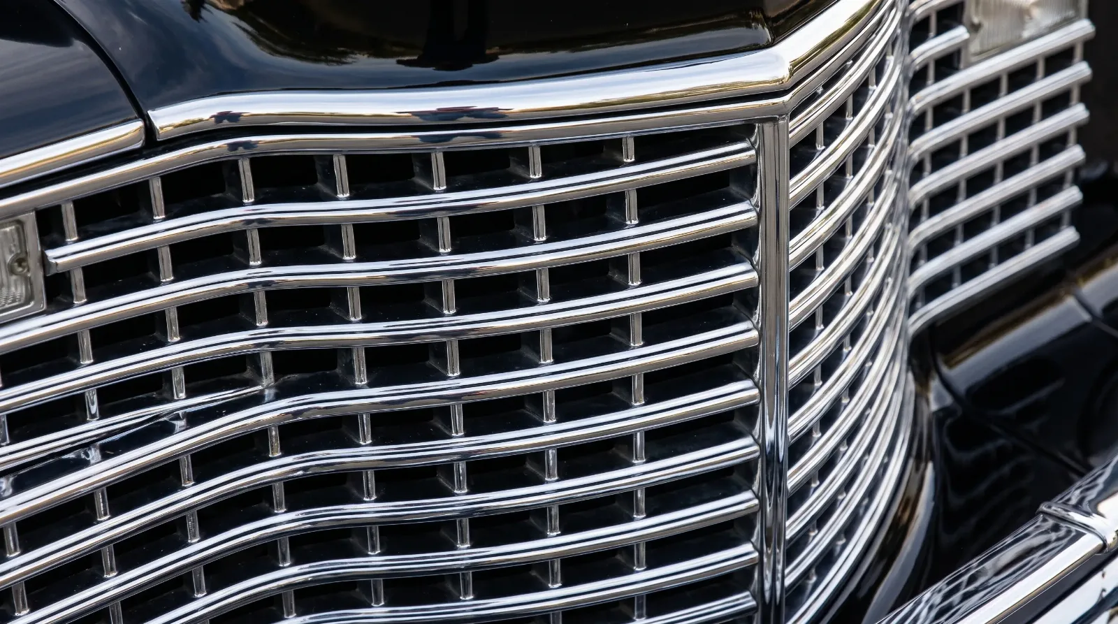 Close-up detail of a 1941 Cadillac chrome egg-crate grille with fine crosshatch of bright bars