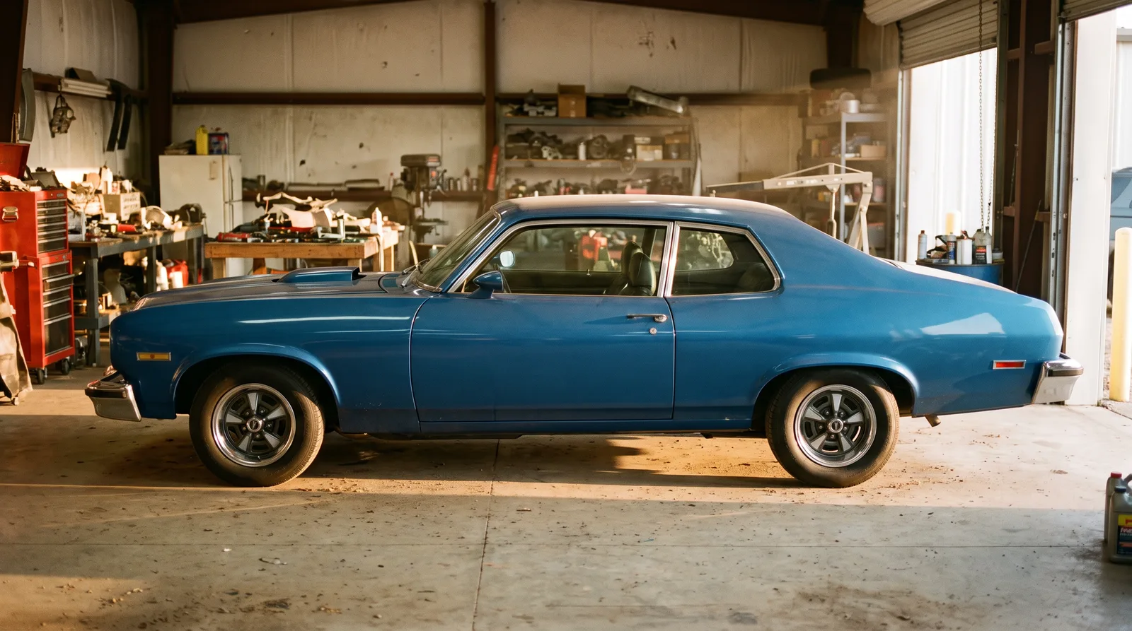 1974 Pontiac GTO, blue coupe in a restoration workshop
