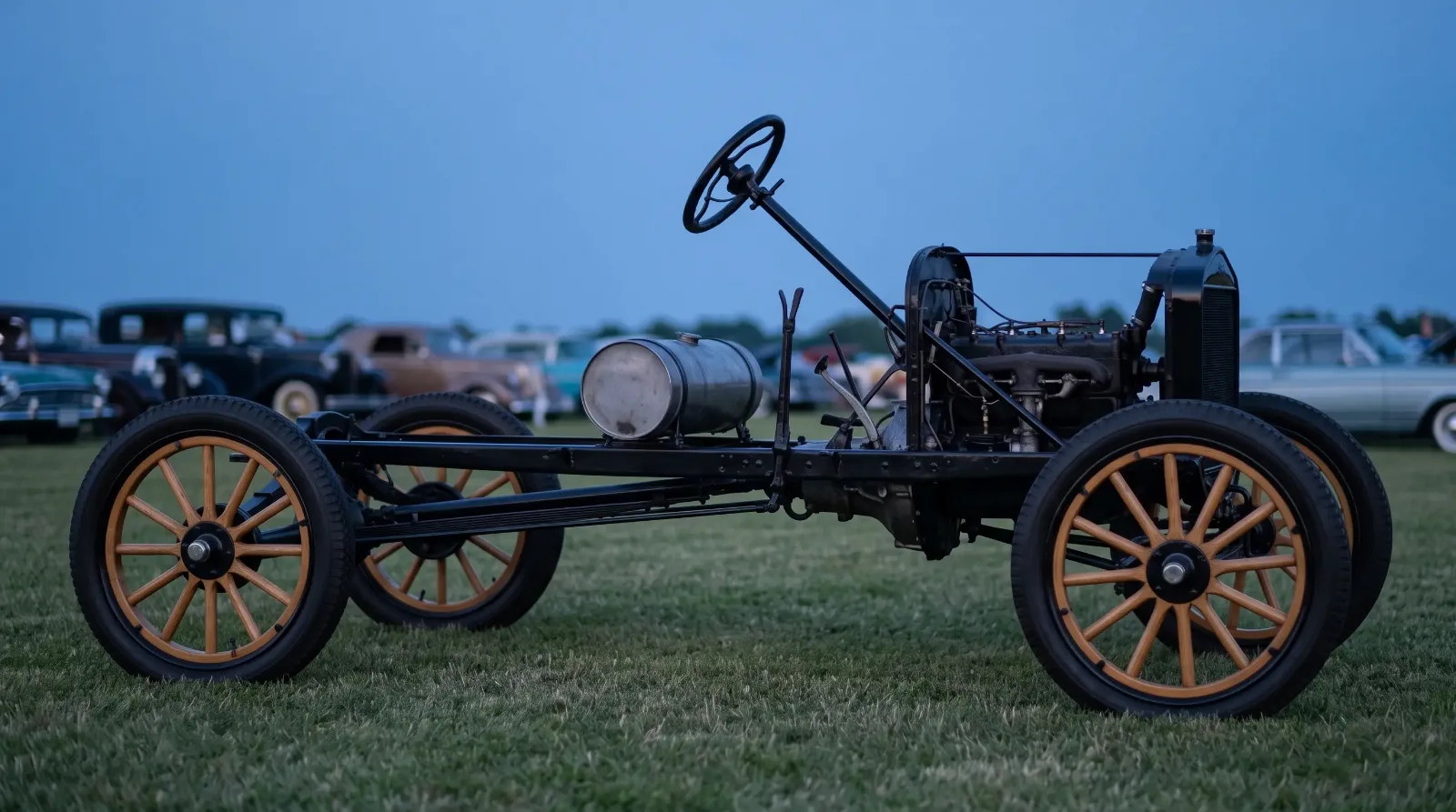 1917 Ford Model T chassis, bare on a show lawn at dusk