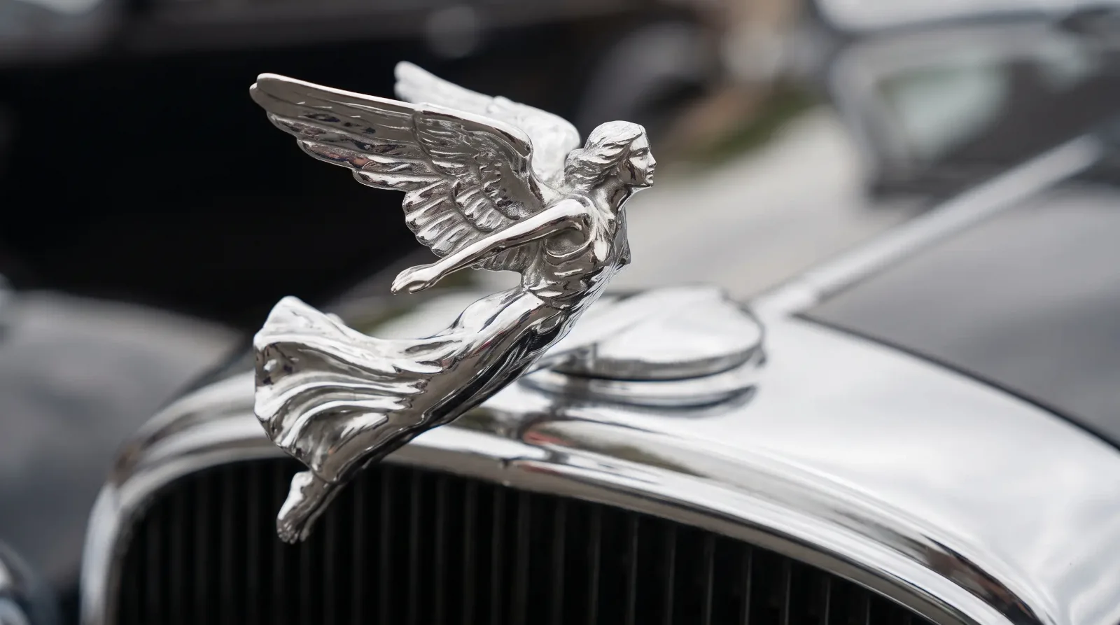 Chrome winged figural hood mascot on a luxury car