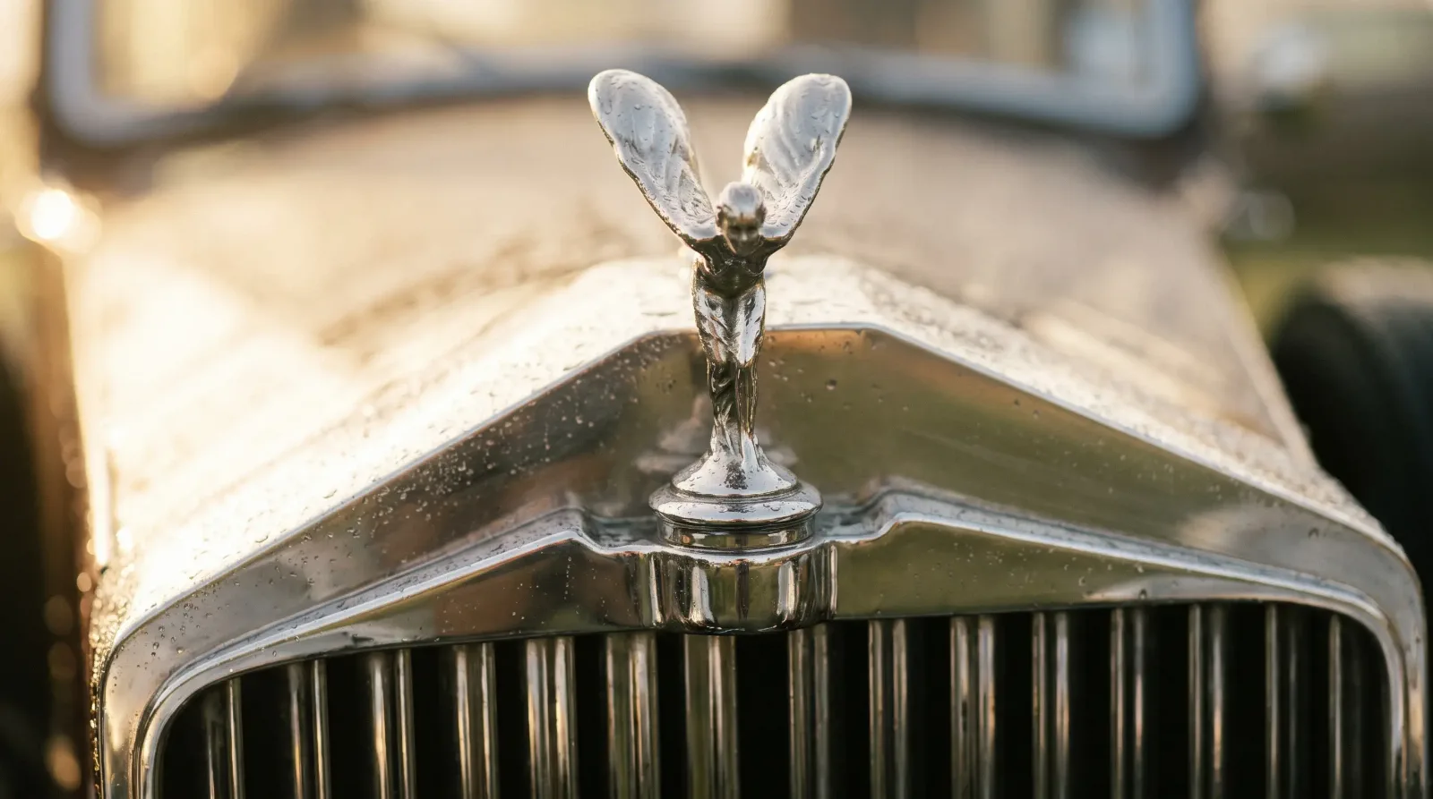 Close-up of the Spirit of Ecstasy hood ornament on a 1934 Rolls-Royce Phantom II chrome radiator shell