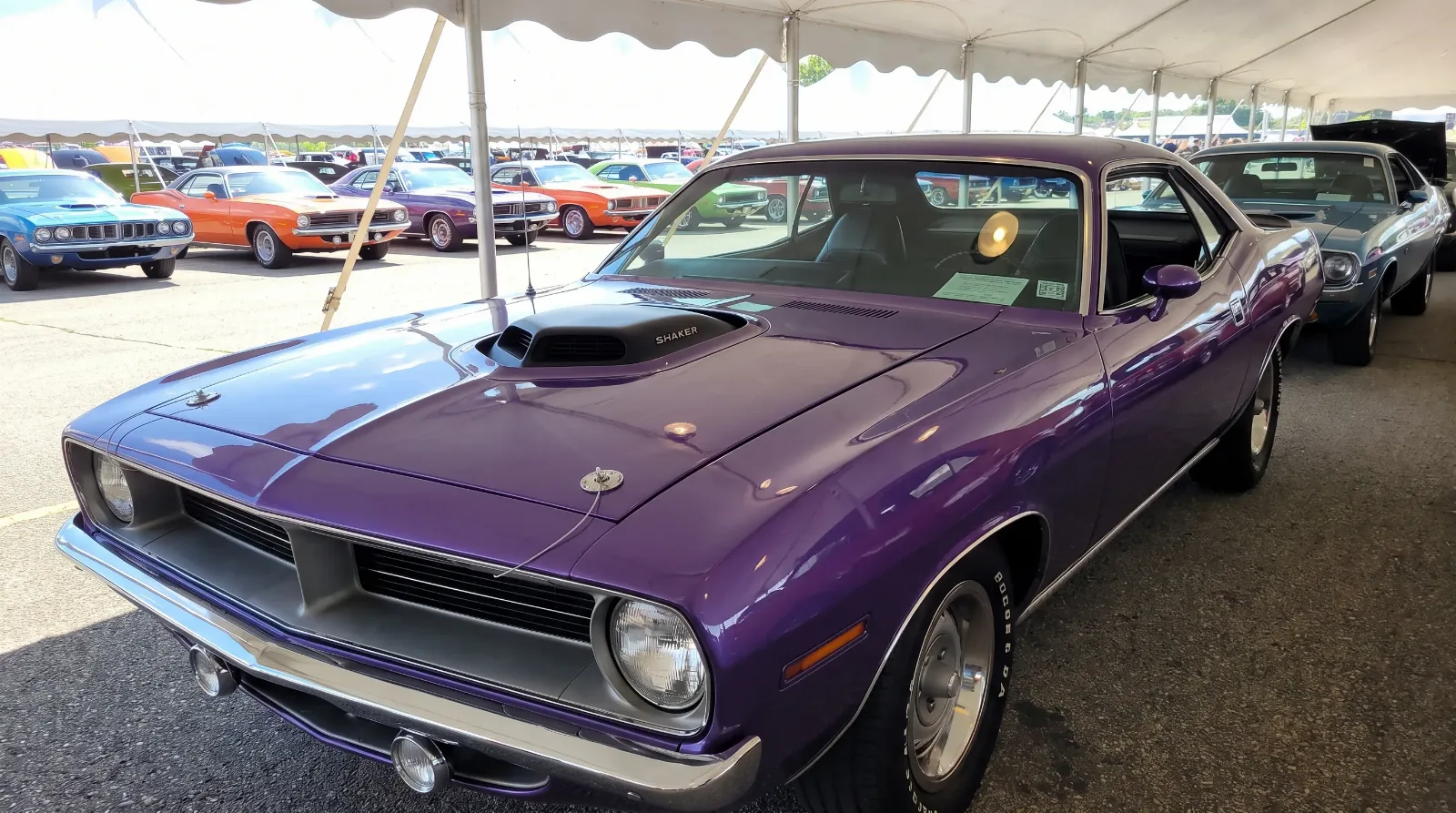 1970 Plymouth Cuda in vivid high-impact factory purple under a car show tent
