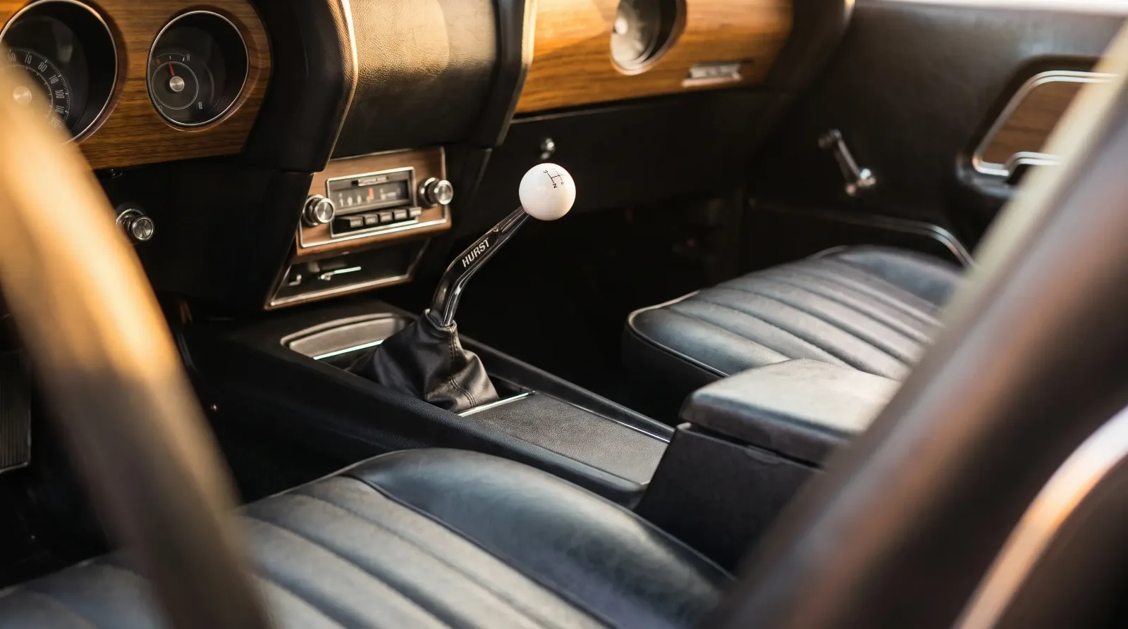 Factory four-speed Hurst shifter and console in a 1969 muscle car interior