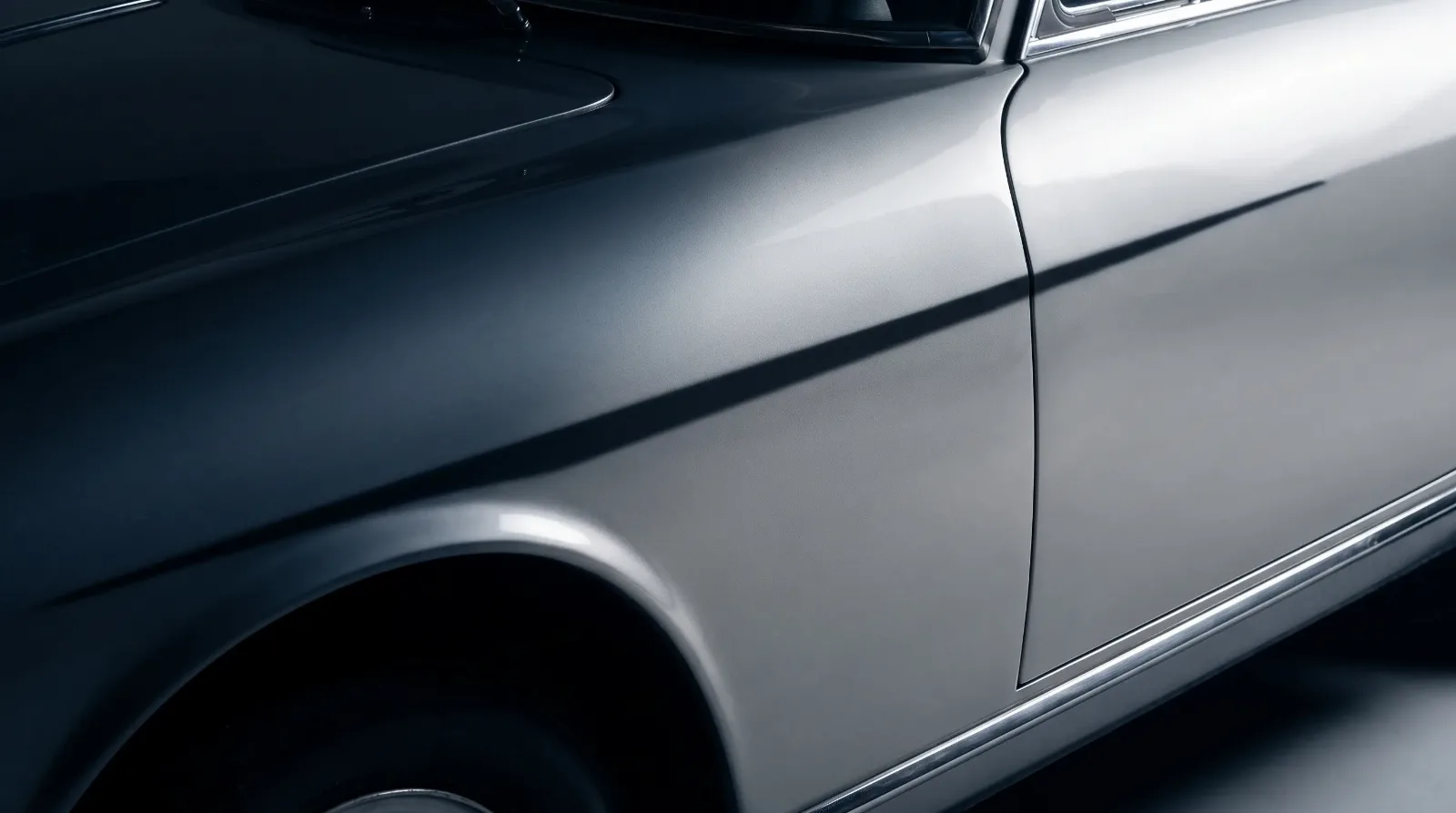 Knife-edge fender styling detail on an Italian-influenced luxury coupe