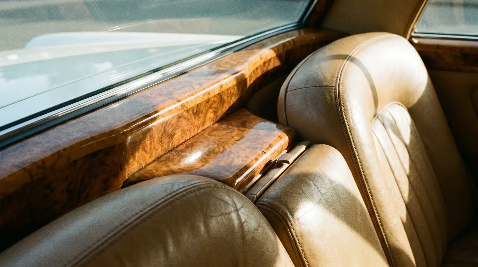 Burl walnut dashboard and hand-stitched leather in a classic luxury car