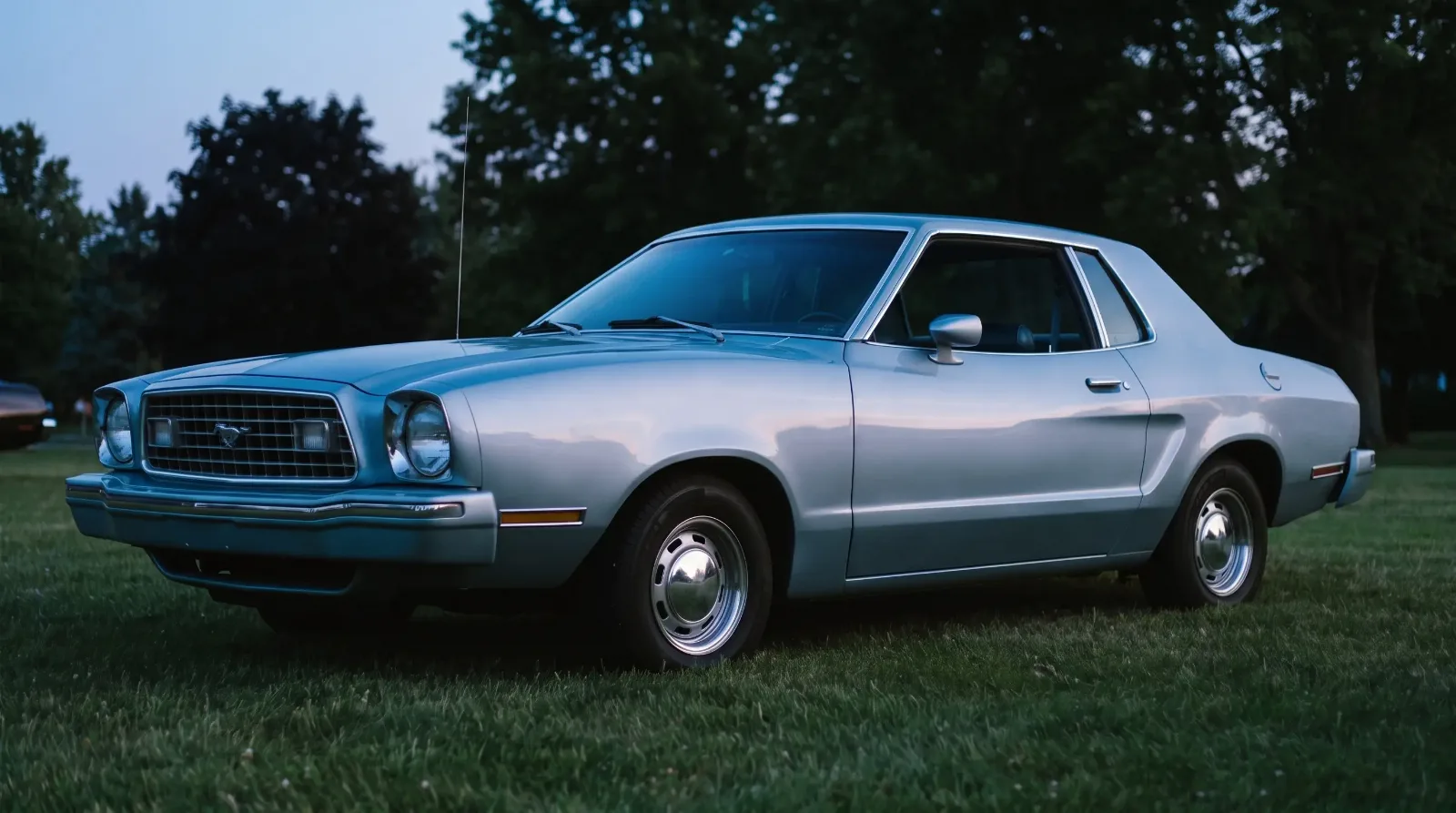 1976 Ford Mustang II notchback, on a show lawn at dusk