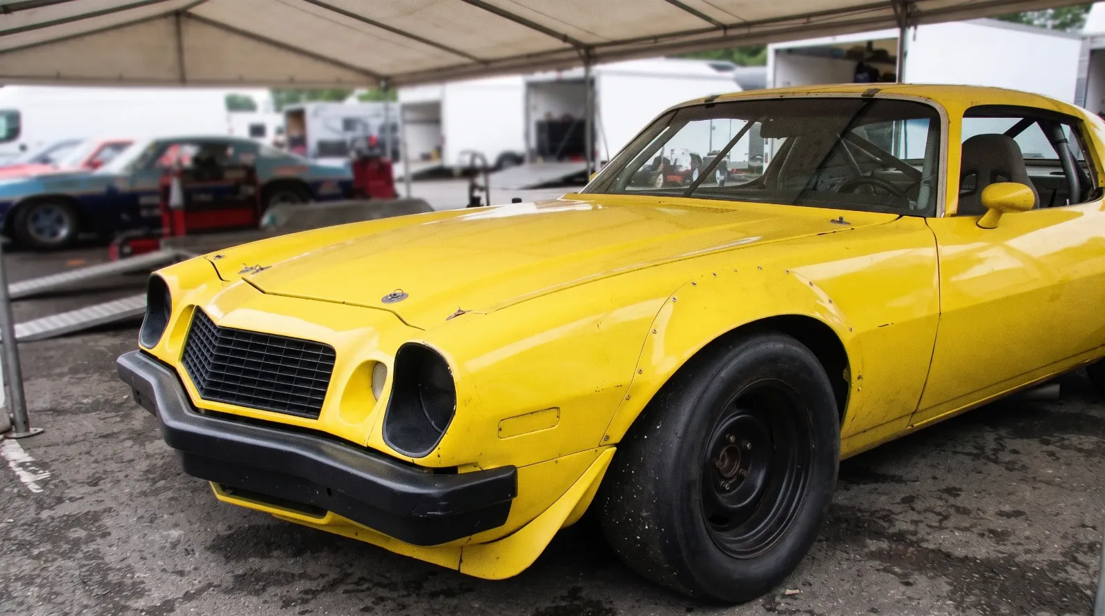 1977 Chevrolet Camaro IROC race car, in the paddock under a tent