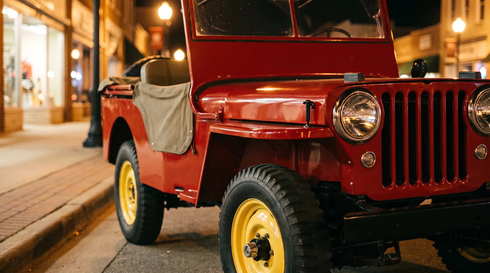 1946 Willys CJ-2A, red jeep front corner on a main street at night