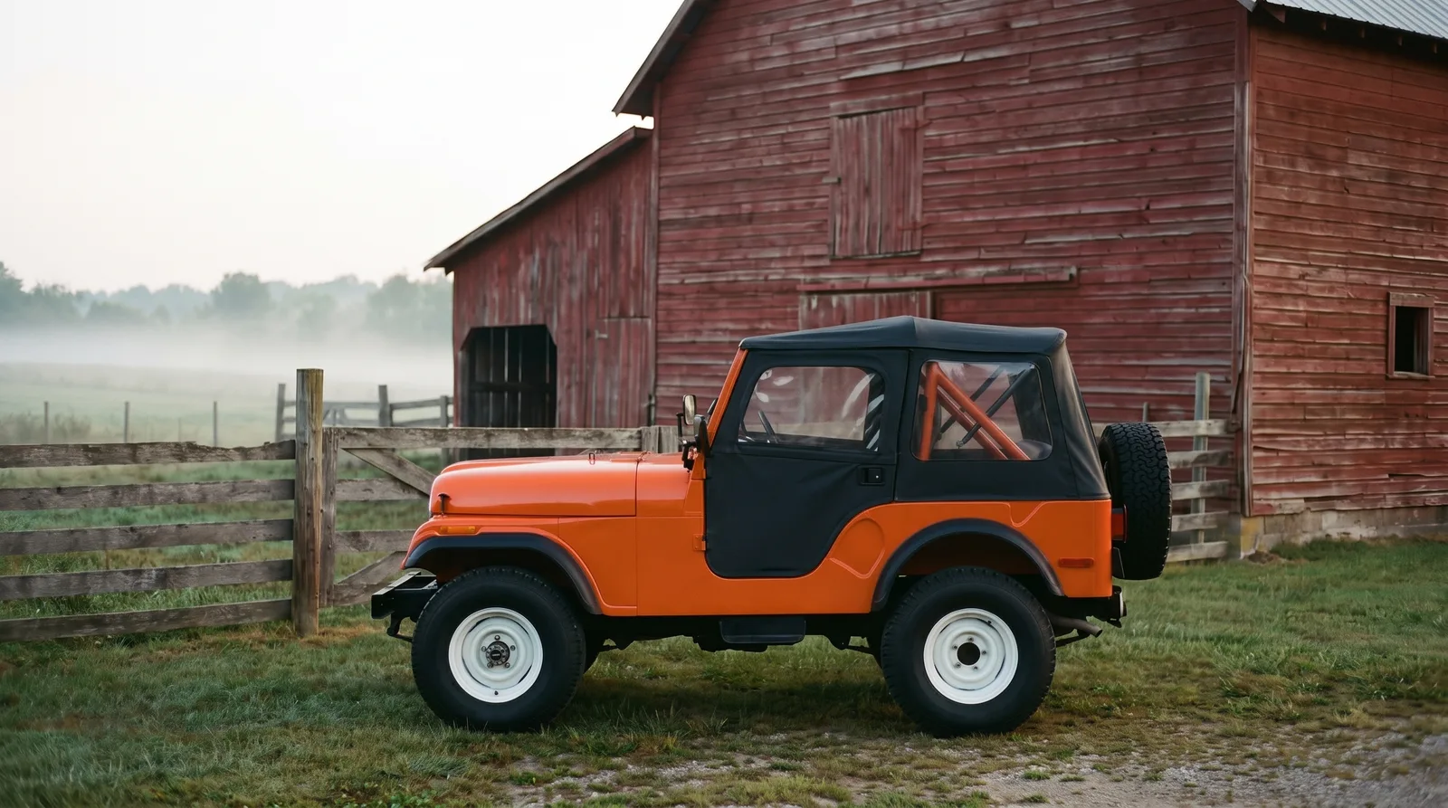 1971 Jeep CJ-5 Renegade, by a red barn in morning mist