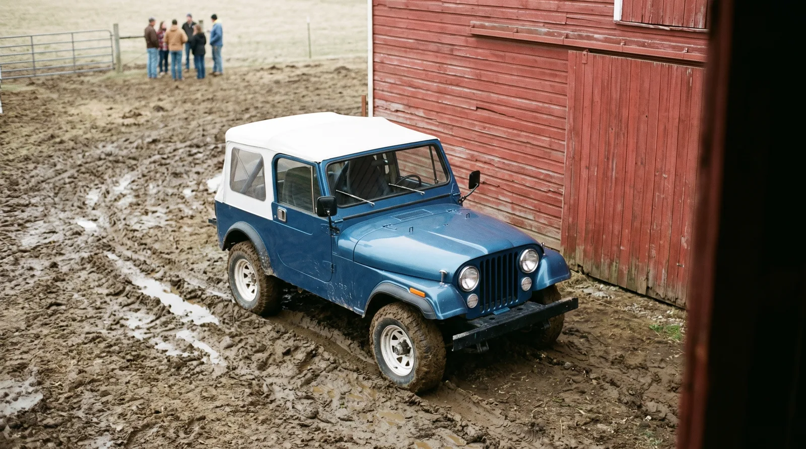 1976 Jeep CJ-7, parked in a muddy barnyard by a red barn