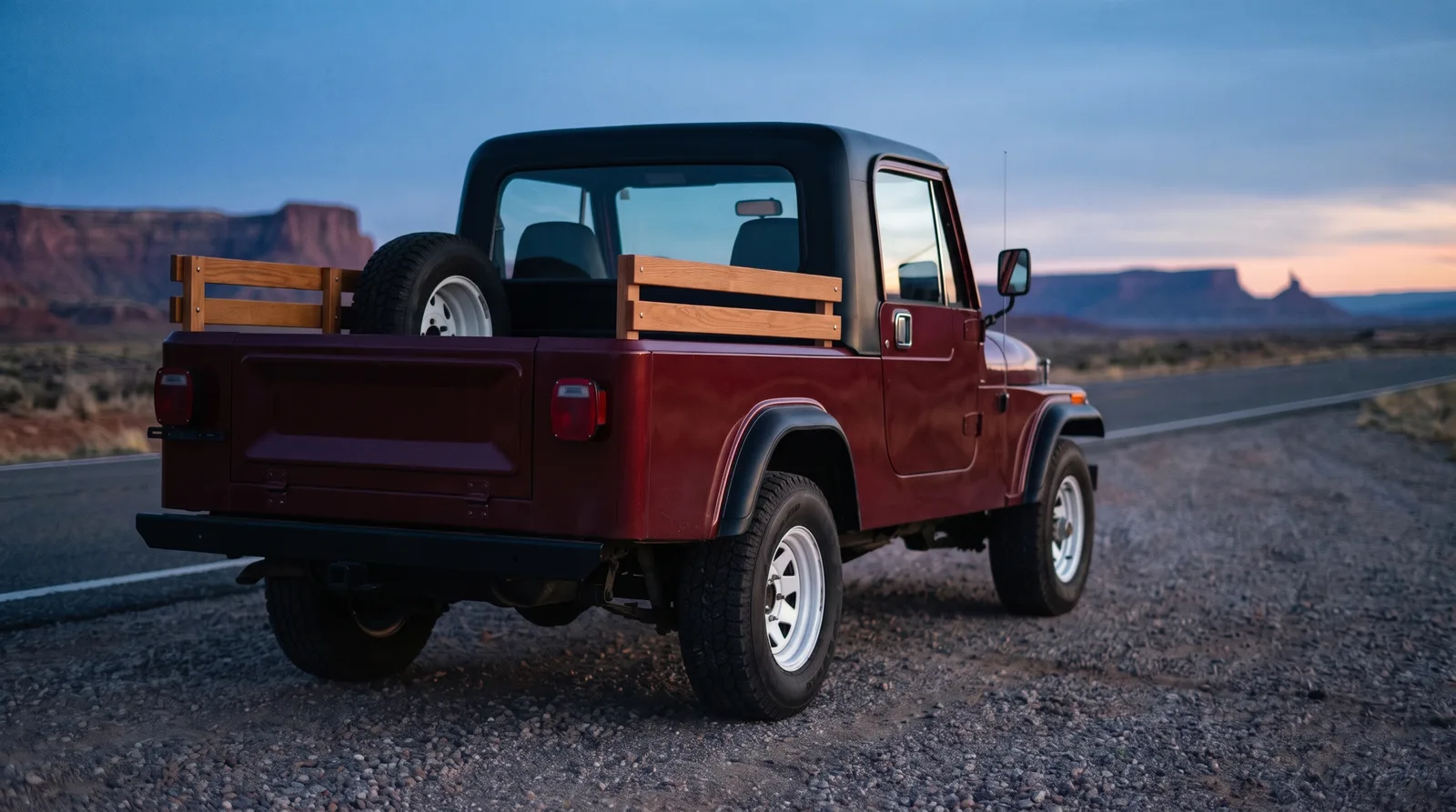 1982 Jeep CJ-8 Scrambler — parked on a desert highway at dusk