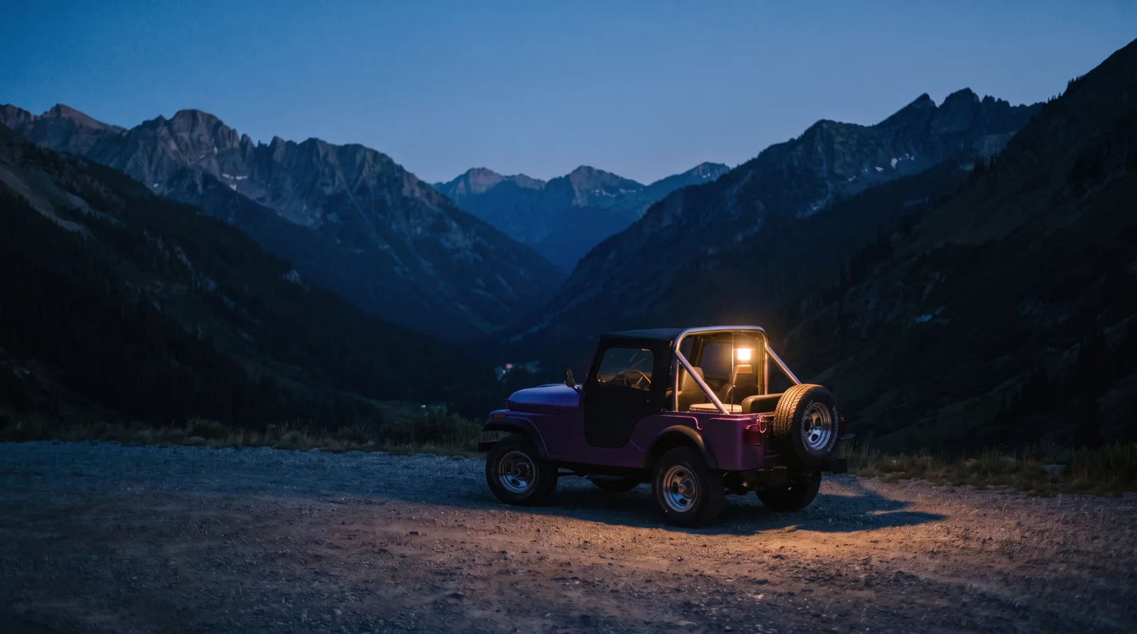 1970 Jeep CJ-5 Renegade, lamp-lit at a mountain pass pull-out