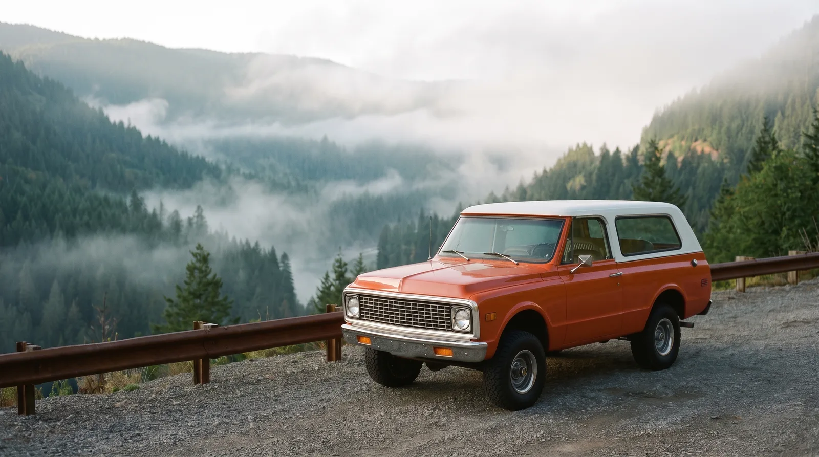 1972 Chevrolet K5 Blazer, two-tone orange at a misty mountain pull-out