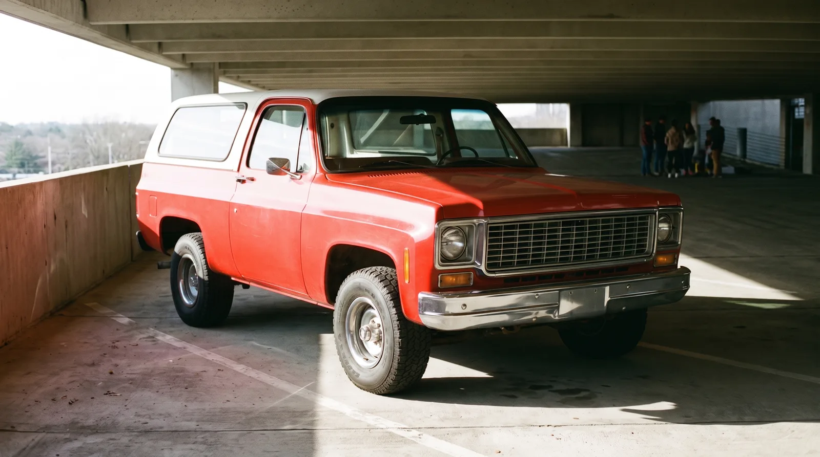 1973 Chevrolet K5 Blazer — parked in a sunlit parking garage